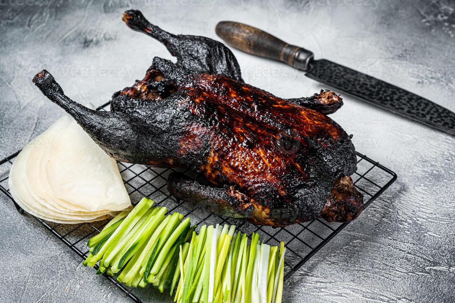 Whole roast Peking duck with herbs, sauce, rice Pancake, Cucumber and onion. White background. Top view photo