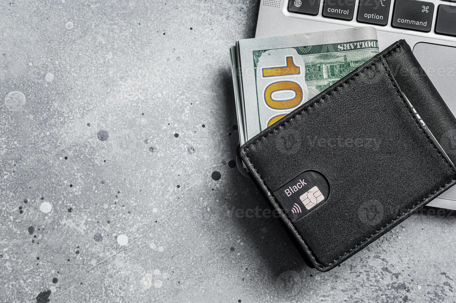 Workplace with stylish leather wallet with money, Laptop. Gray background. Top view. Copy space photo