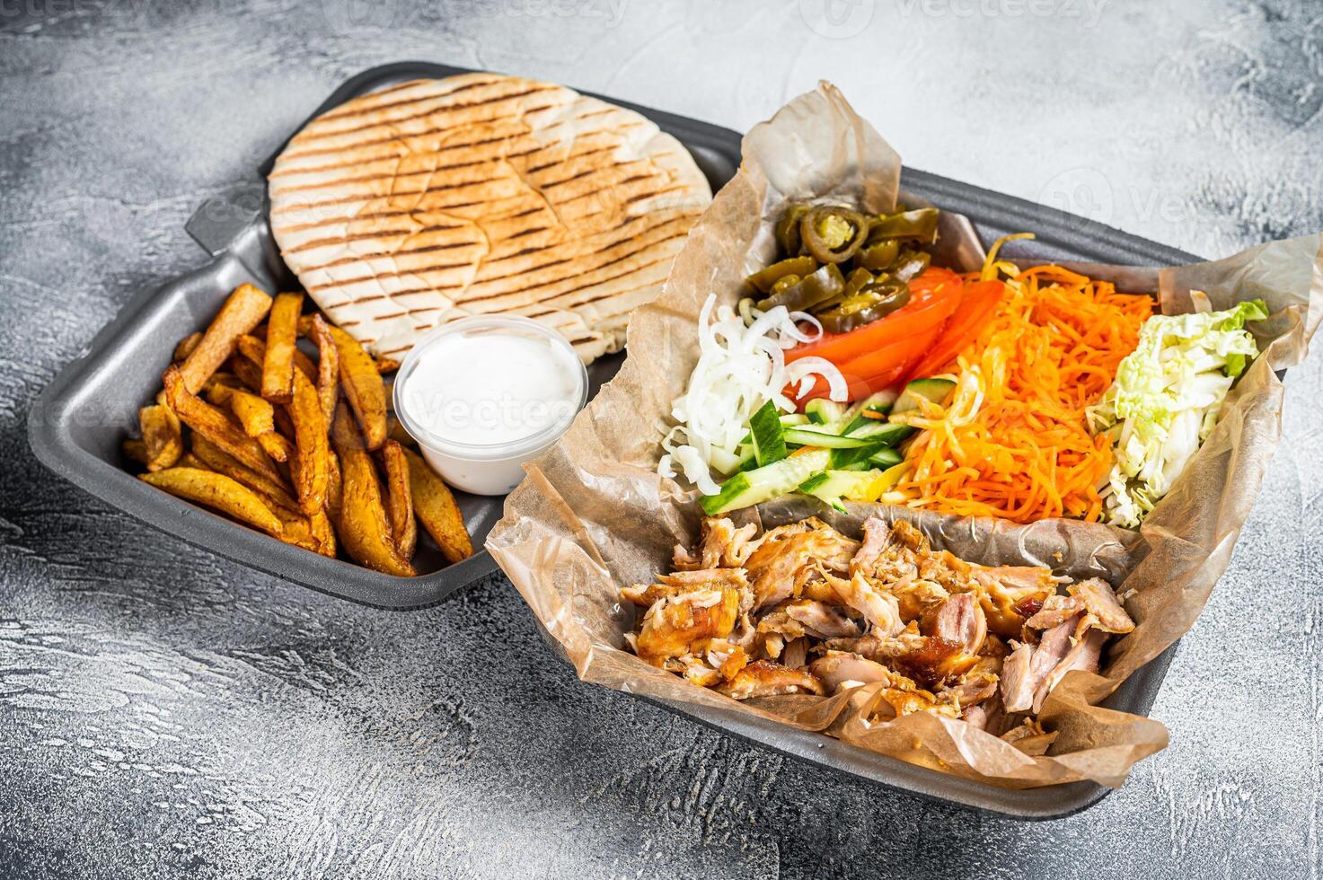 Doner kebab Shawarma on a plate with french fries and salad in box to go, take away. White background. Top view photo