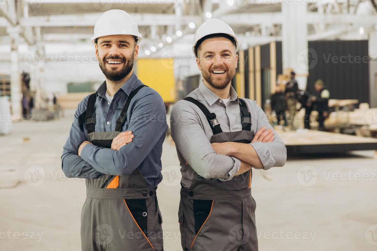 Engineers smiling with arms crossed in modular building factory photo