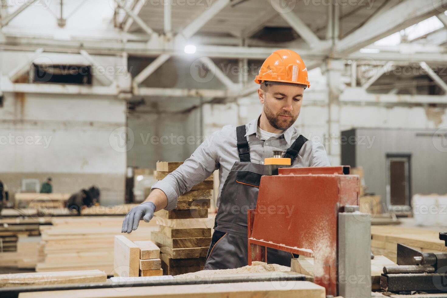Carpenter cutting wooden planks in a factory for modular building photo