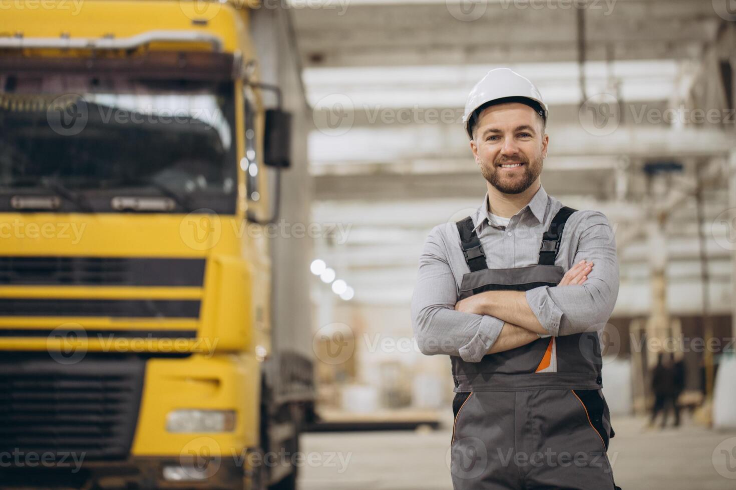 Engineer smiling with crossed arms in modular building factory photo