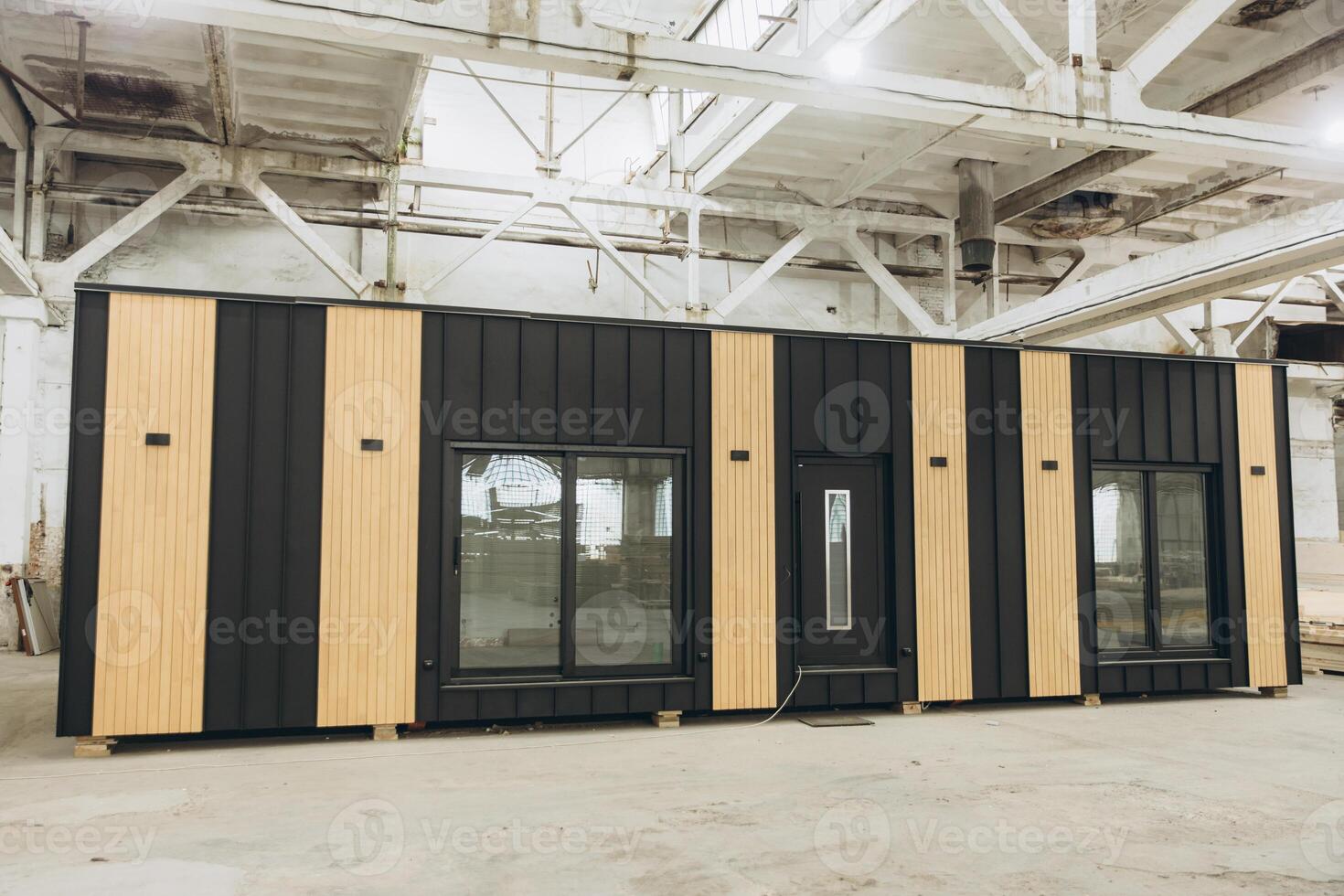 Modular building under construction inside a large industrial facility photo