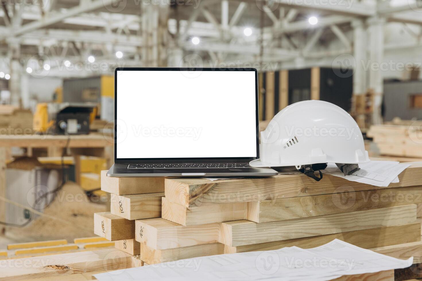 Laptop showing blank screen on lumber in modular building factory photo