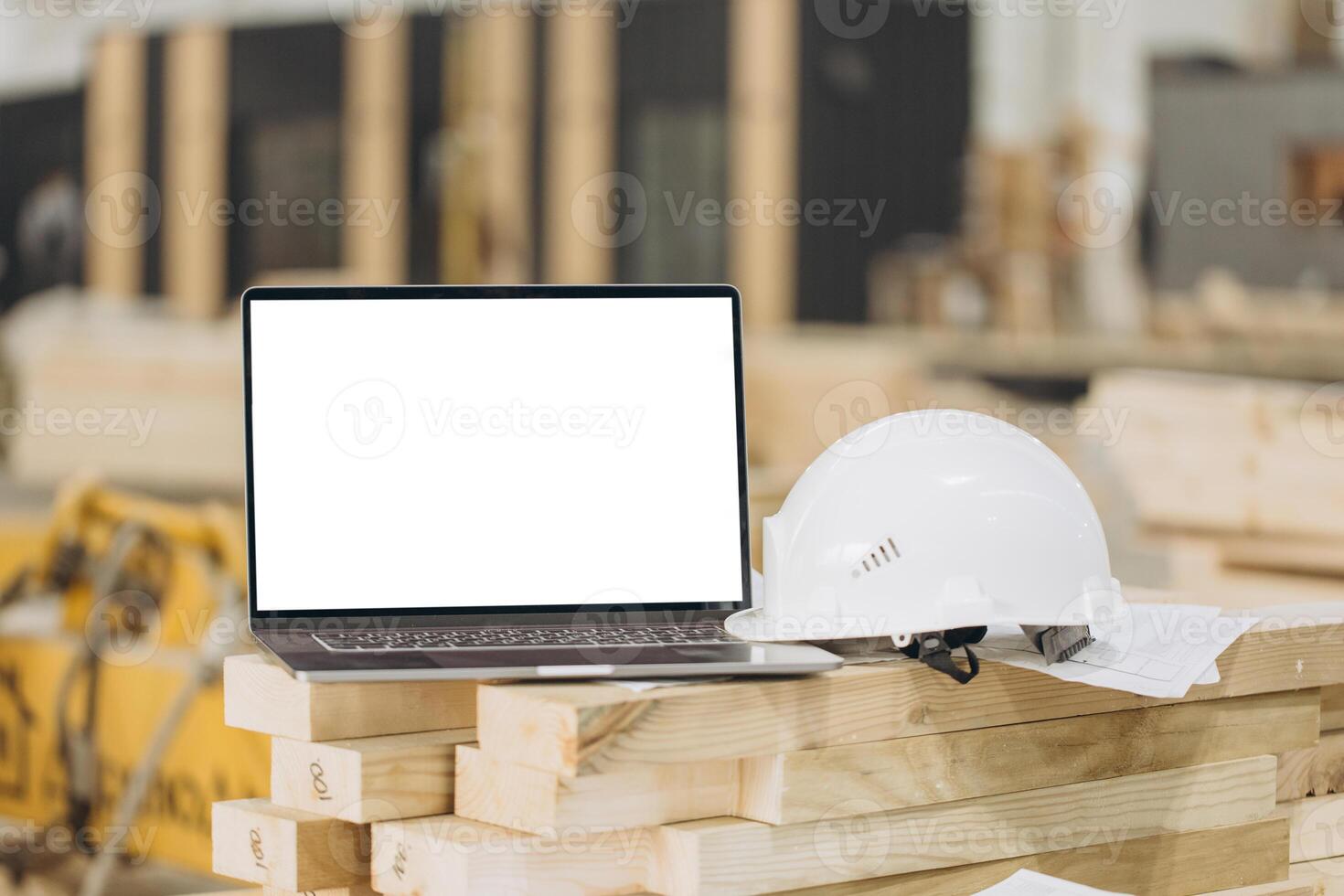 Laptop showing mockup screen with white hard hat in modular building industry photo