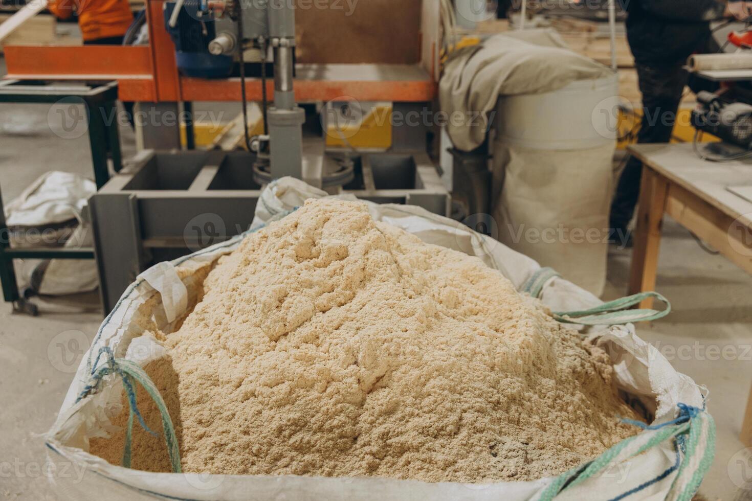 Sawdust filling big bag in carpentry workshop for modular building industry photo