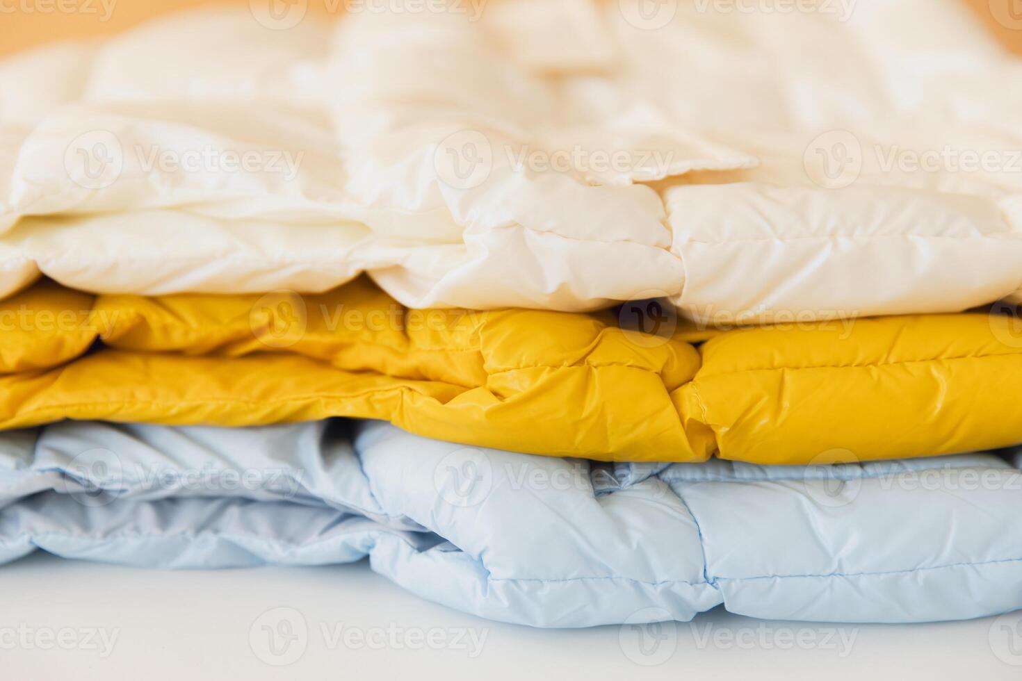 Stack of colorful winter jackets creating warmth and style photo