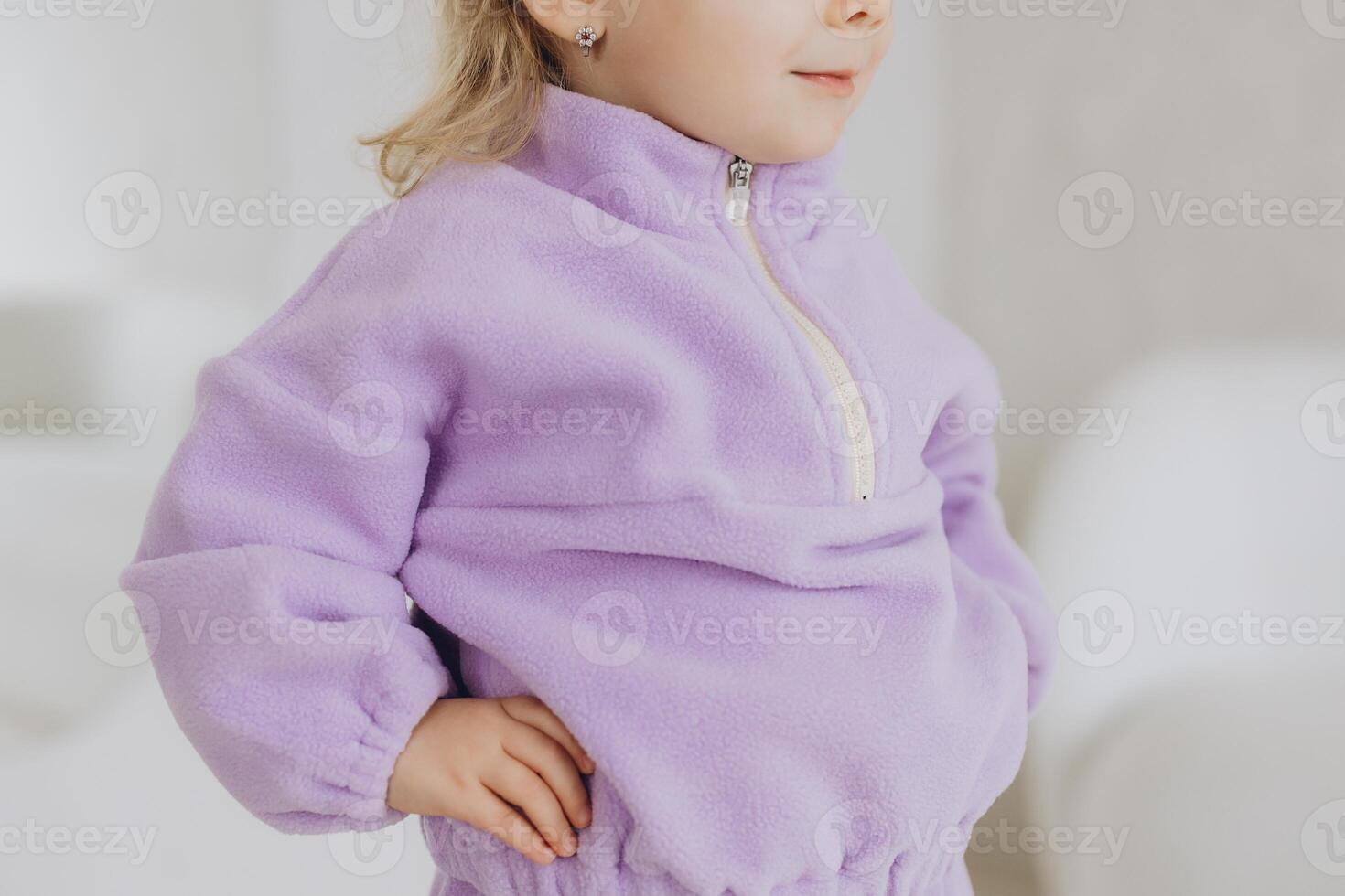 Little girl wearing purple fleece jacket mockup posing indoors photo