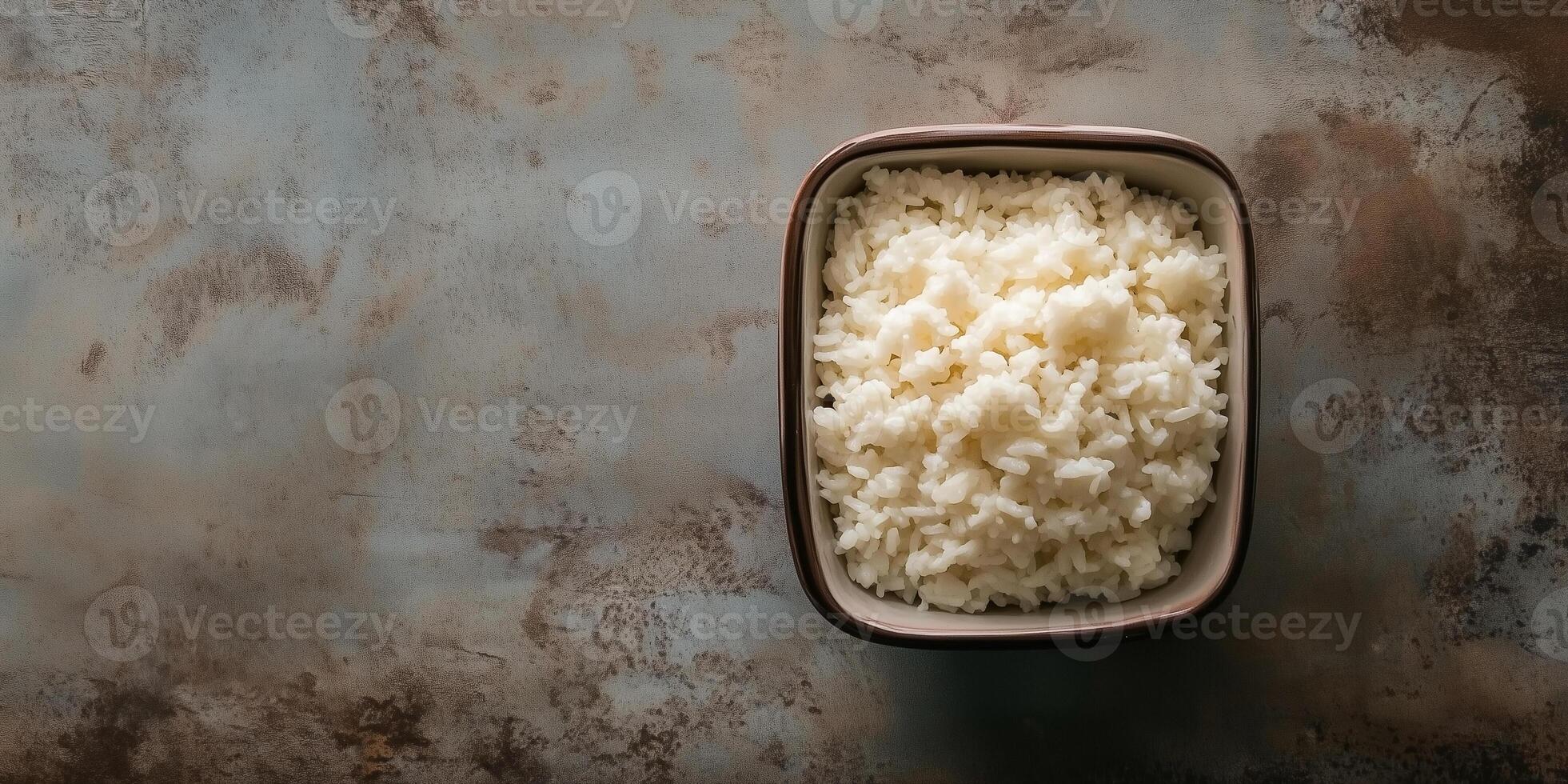 Sticky rice served in a compact square ceramic container on a table, food setting photo