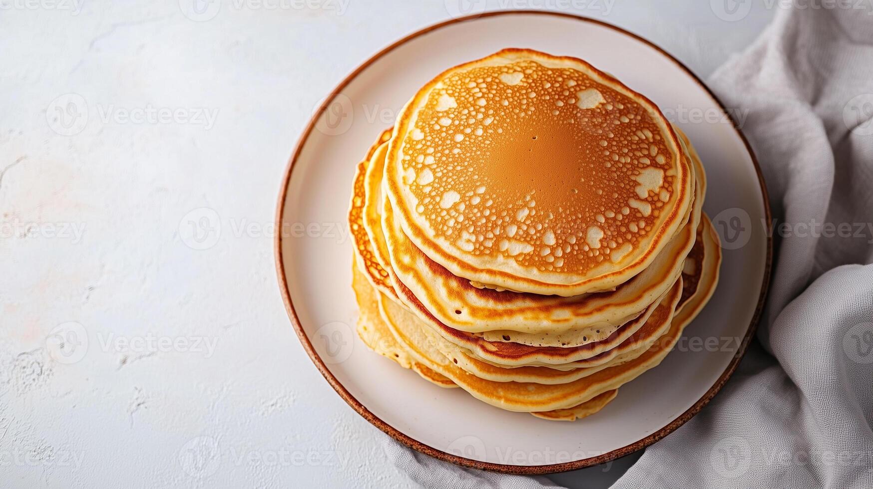 Plate of buttermilk pancakes arranged in a stack in the middle, culinary photography photo