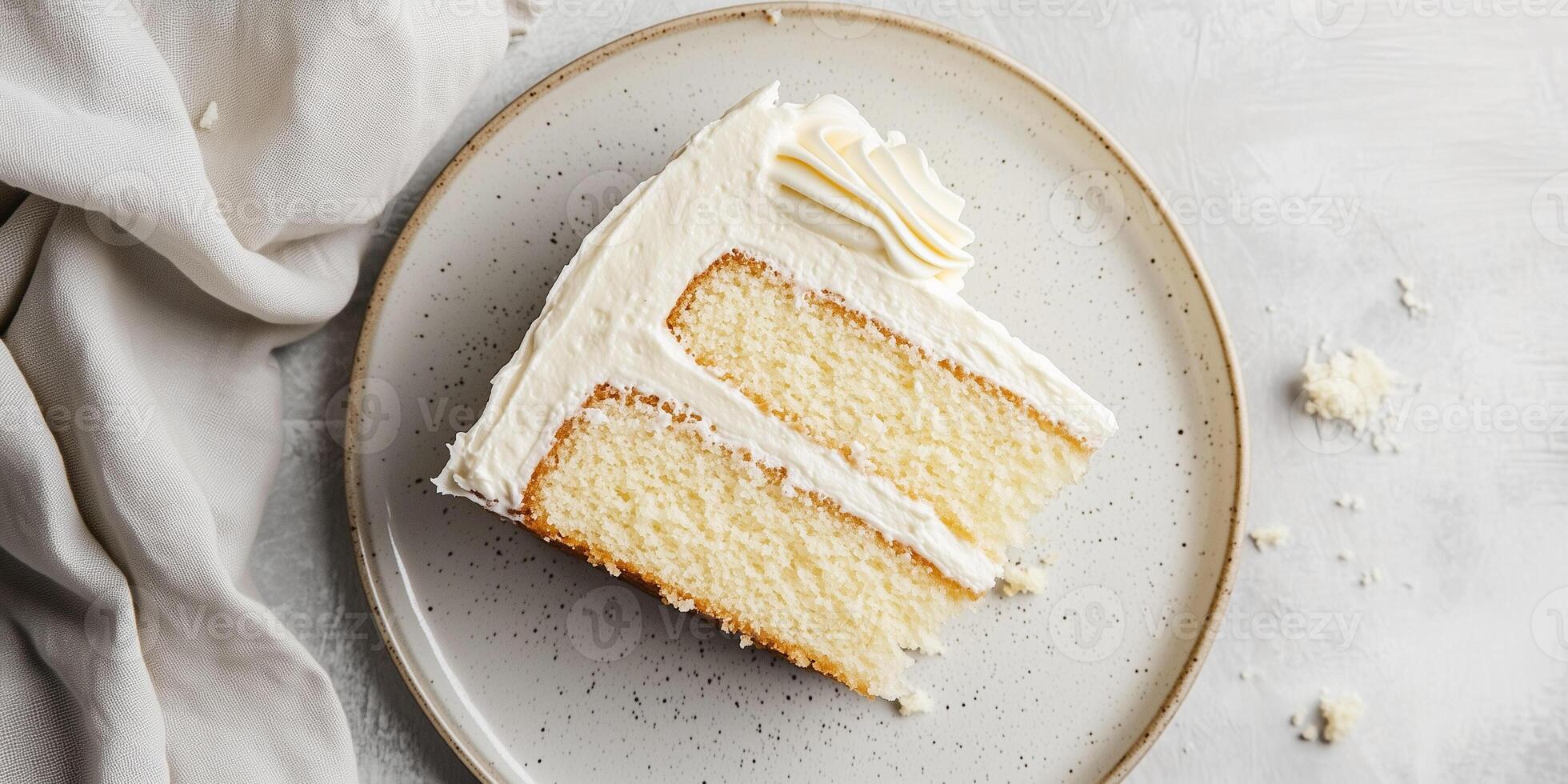 Slice of gluten-free cake on a plate showing layers of sponge and frosting, culinary photography photo
