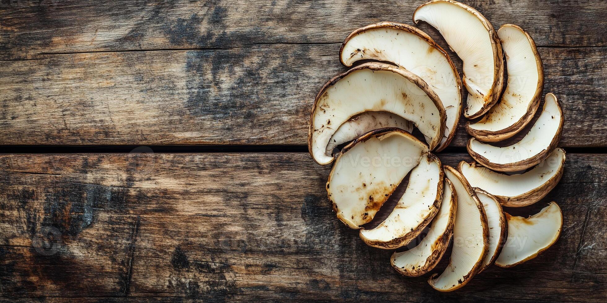 Sliced porcini mushrooms arranged in a fan shape on a wooden surface, food photography photo