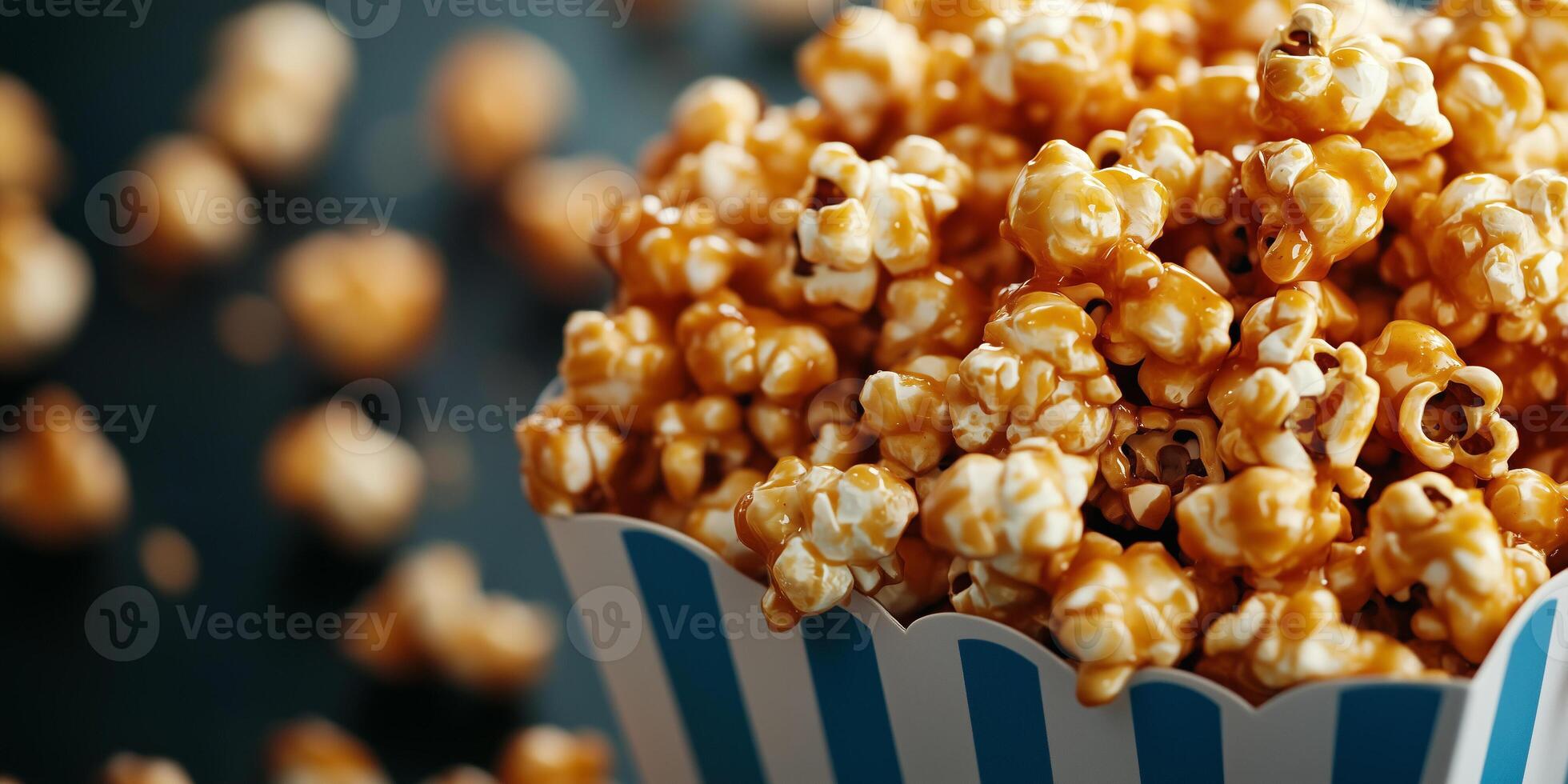 Container filled with caramel corn, with coated kernels spilling over, gastronomy photography photo