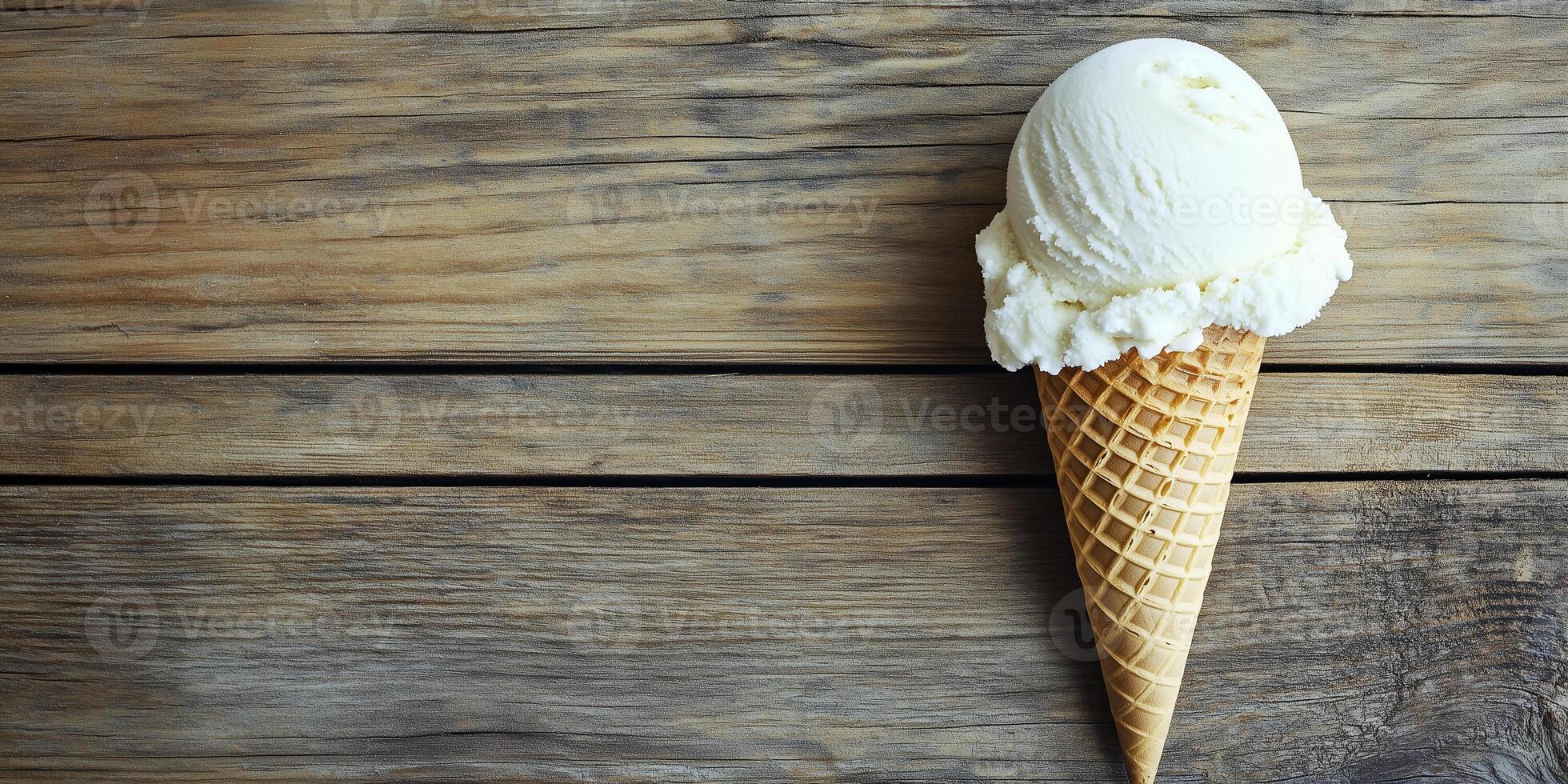 Dairy-free ice cream cone on a wooden surface, scoop leaning slightly, food setting photo