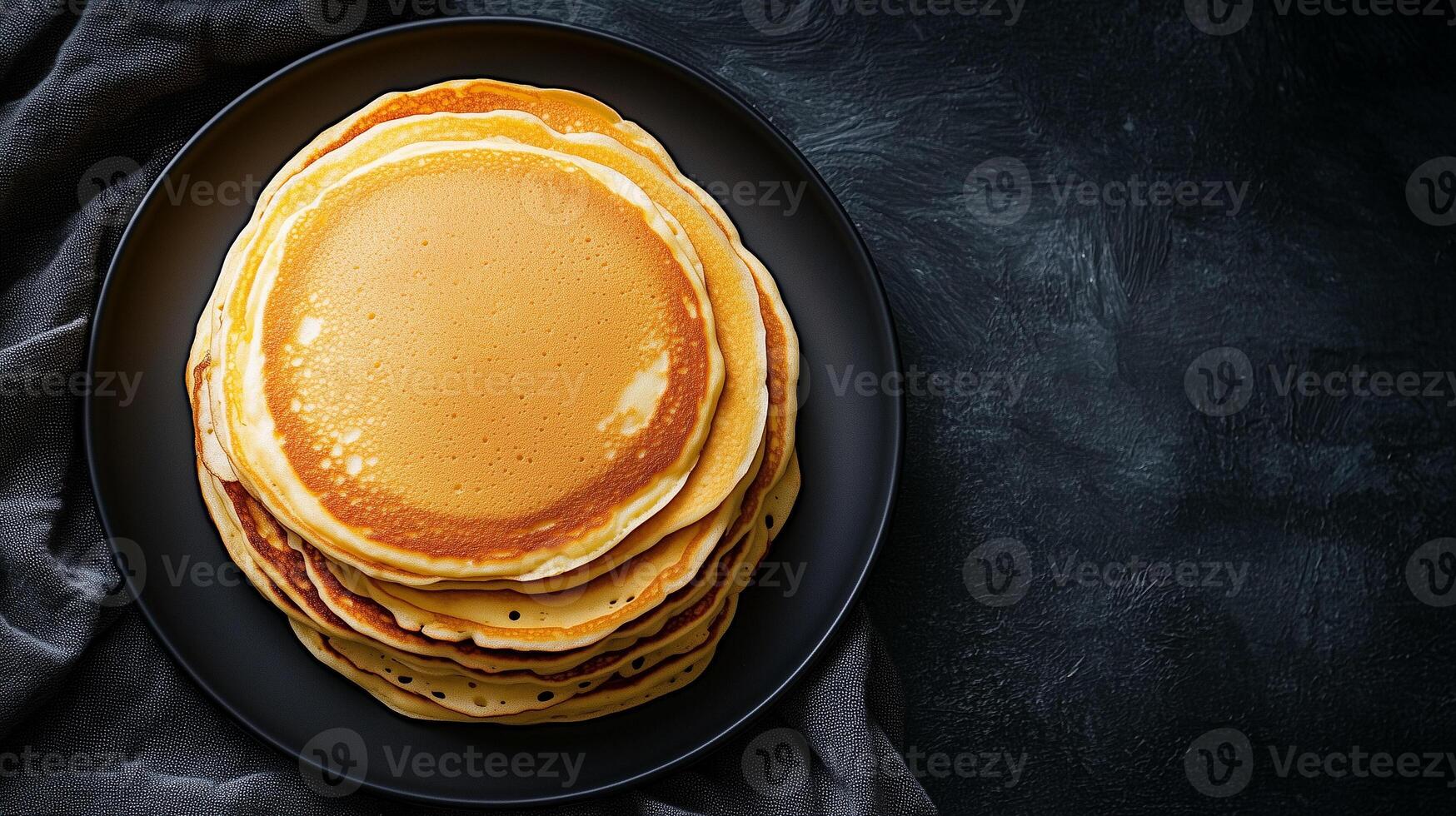 Plate of buttermilk pancakes arranged in a stack in the middle, food setting photo