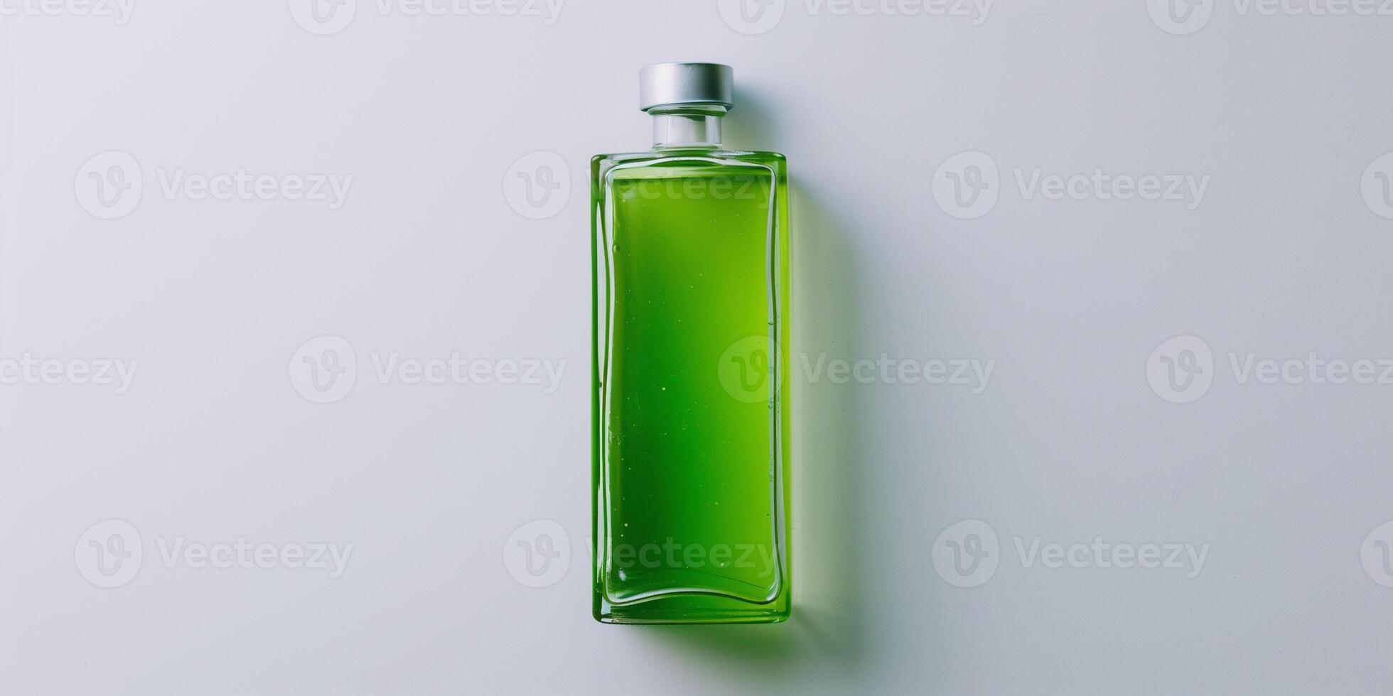 Transparent bottle containing a green liquid, positioned upright on a plain white background, food photography photo