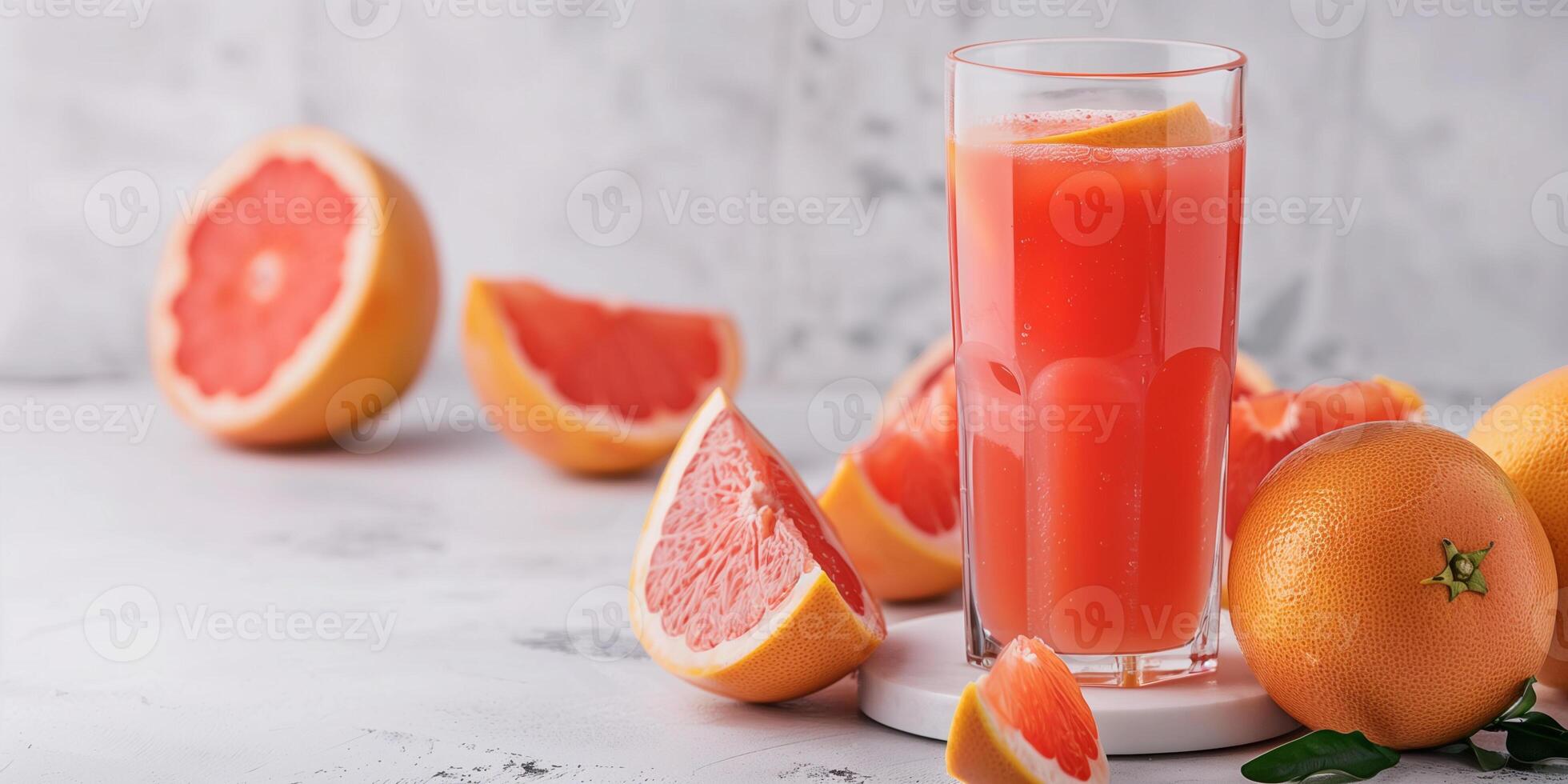 Glass filled with freshly squeezed grapefruit juice, set on a simple white tabletop, gastronomy photography photo
