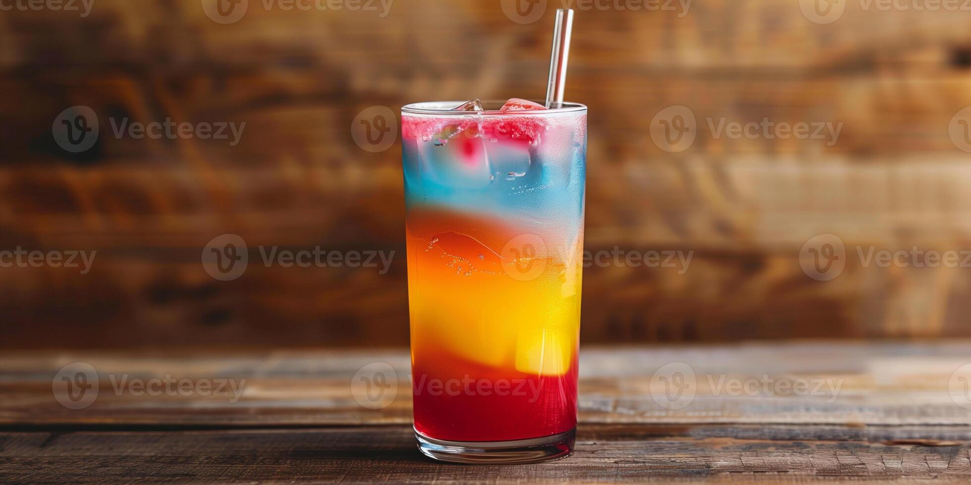 Tall glass of layered, colorful beverage with a straw, on a wooden surface, food setting photo