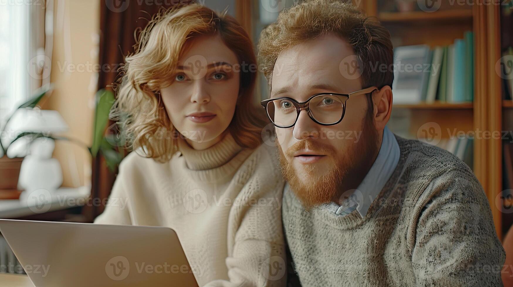 A man and woman looking at a laptop photo