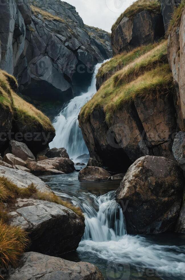 A serene waterfall cascading through rocky cliffs, surrounded by lush greenery. photo
