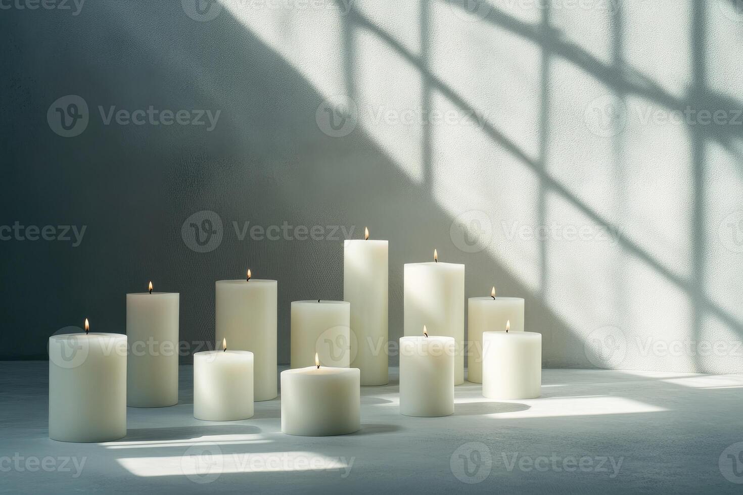 Burning White Candles on a Grey Surface With Shadow Patterns photo