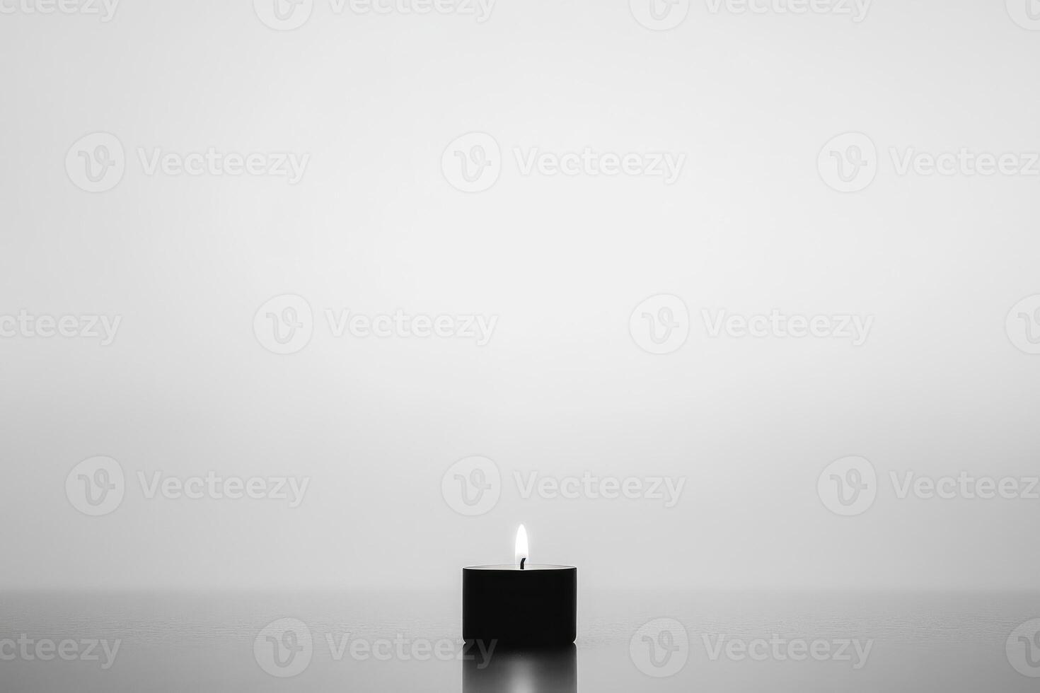 A Single Lit Candle on a Smooth Surface photo