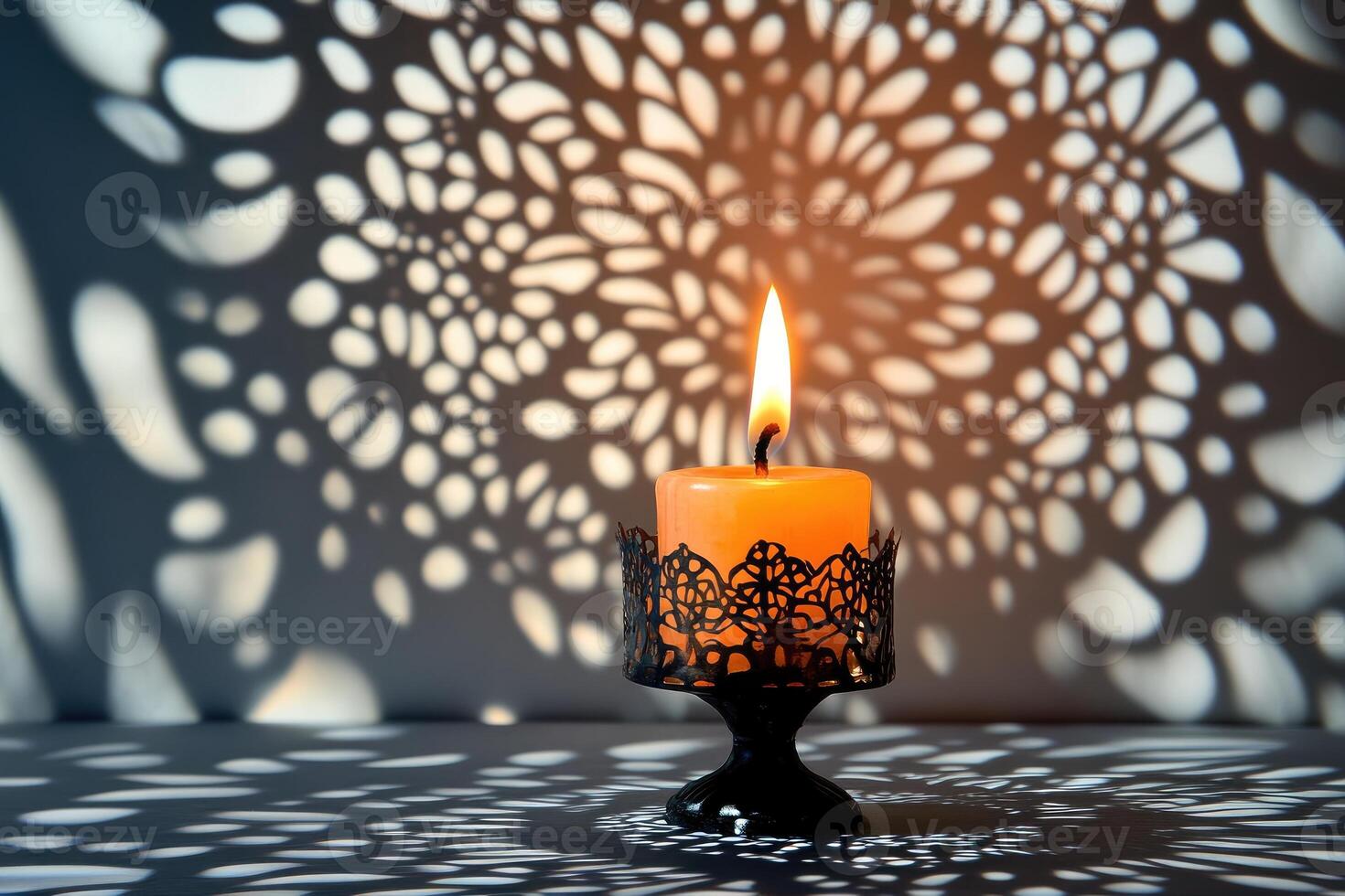 A Single Candle in a Decorative Holder with Intricate Shadow Patterns photo
