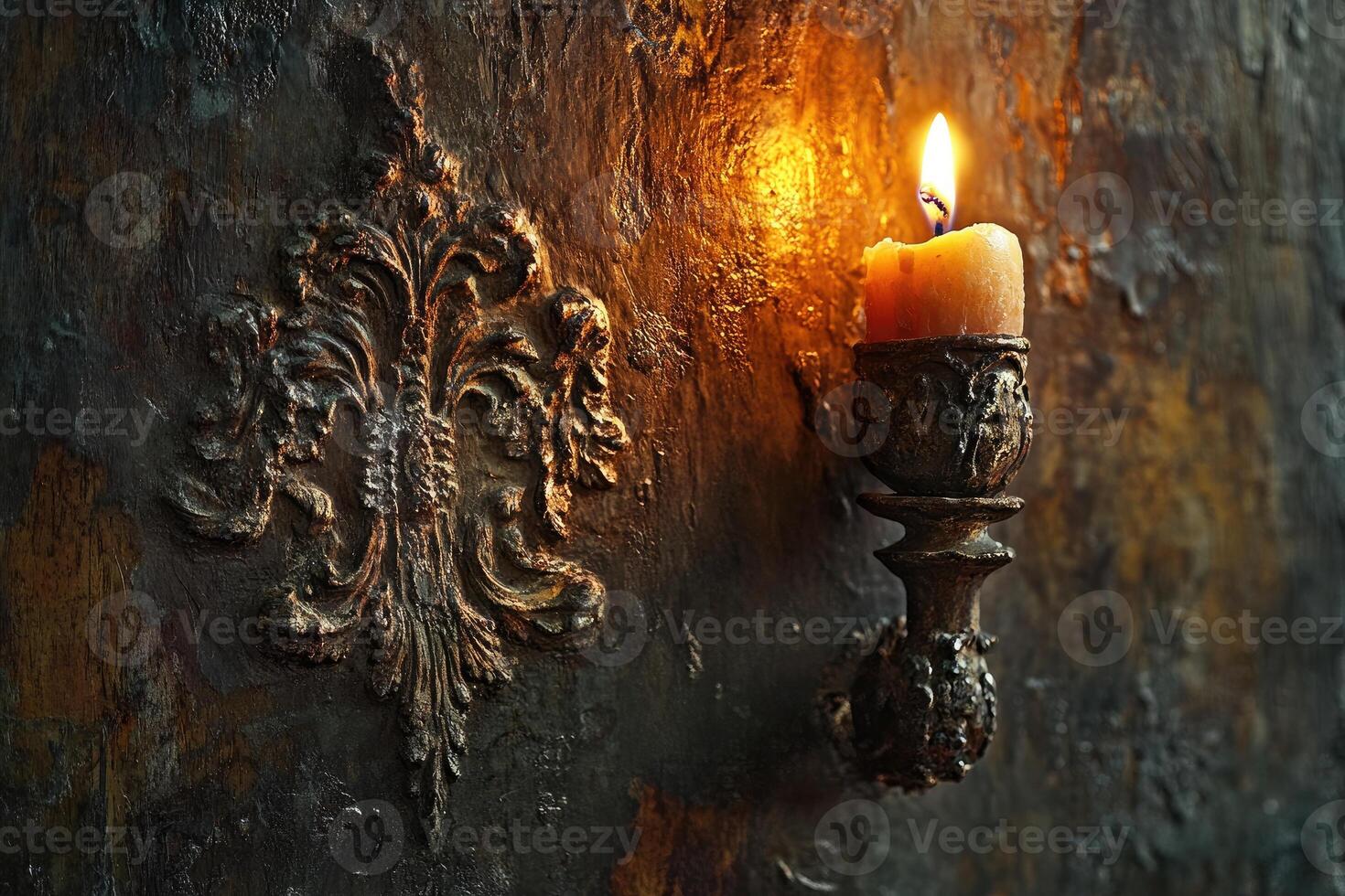A Single Candle Burning in an Ornate Metal Candelabra photo
