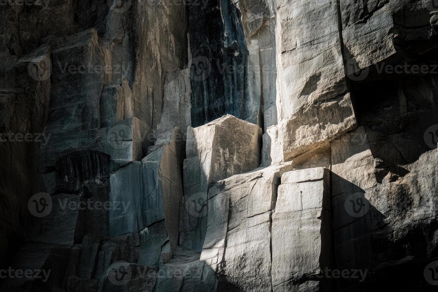 A Close-Up of a Rough, Gray Rock Face with Sunlit Patches photo