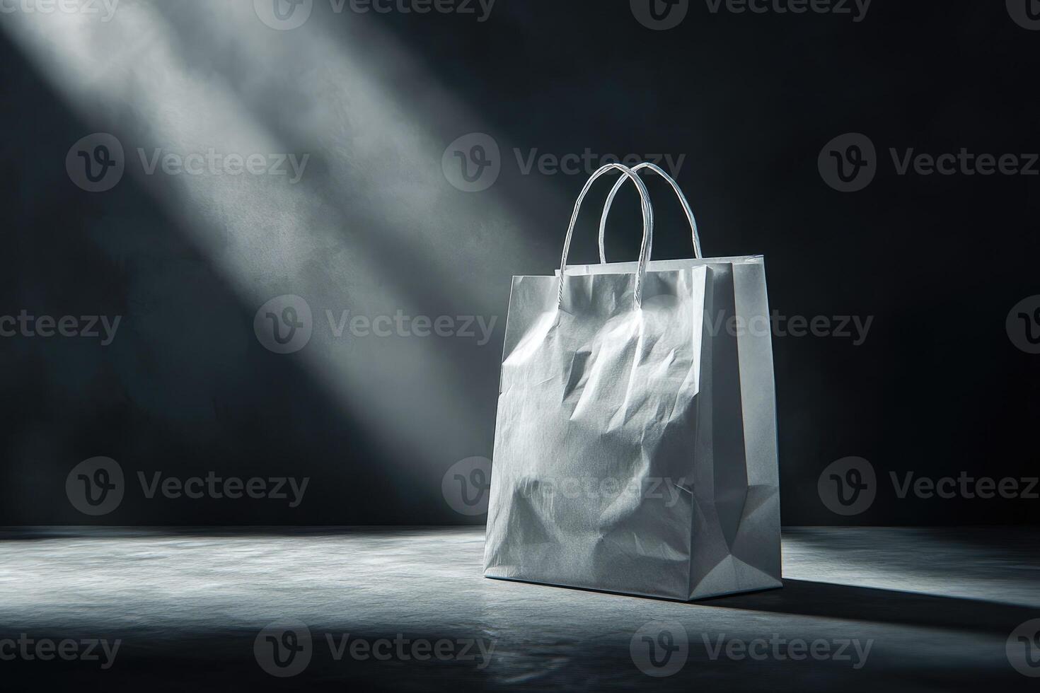 Crumpled White Paper Shopping Bag on a Dark Background with Light Rays photo