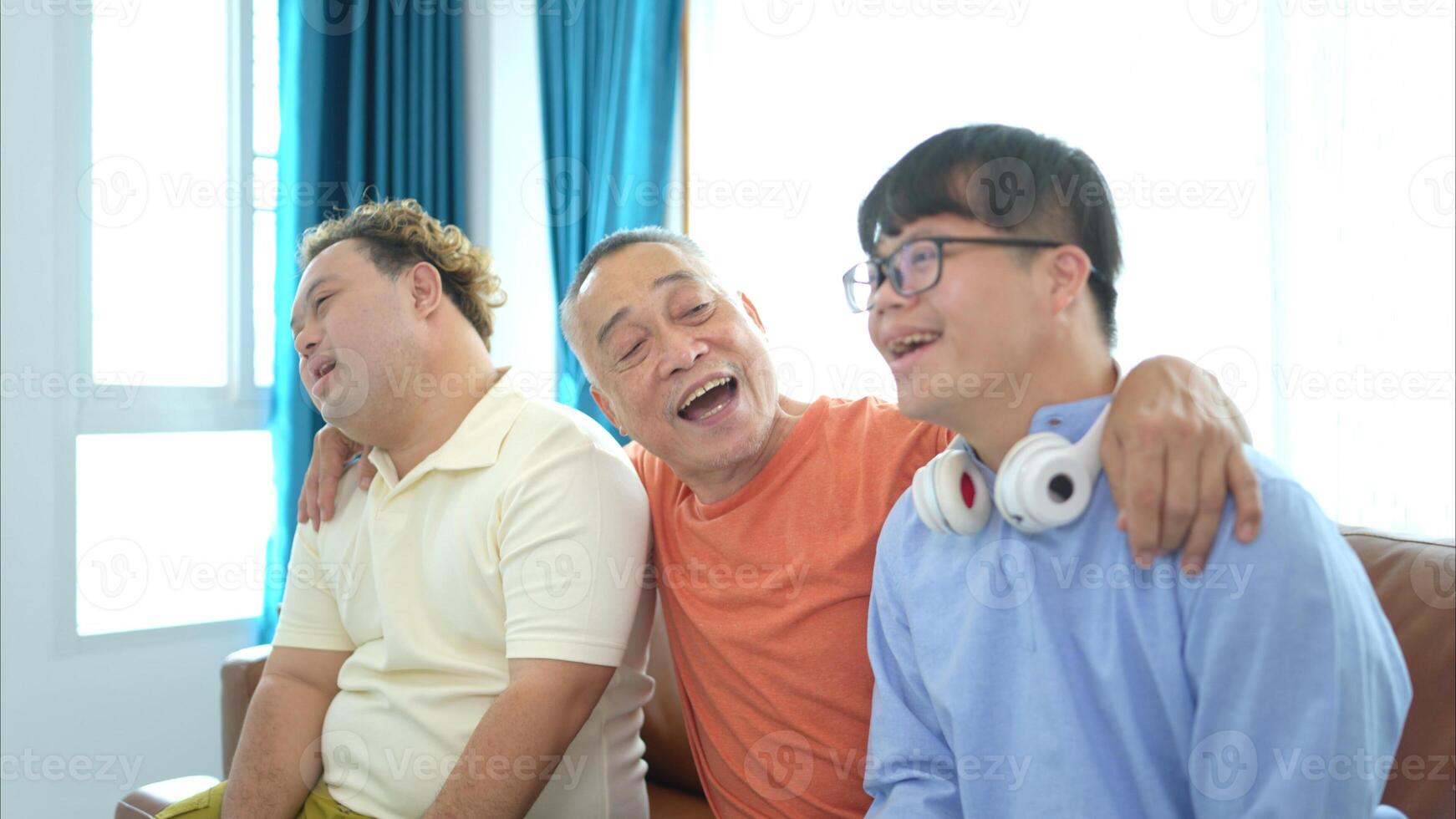 A family with an autistic child enjoys singing and dancing together at home during the holidays photo