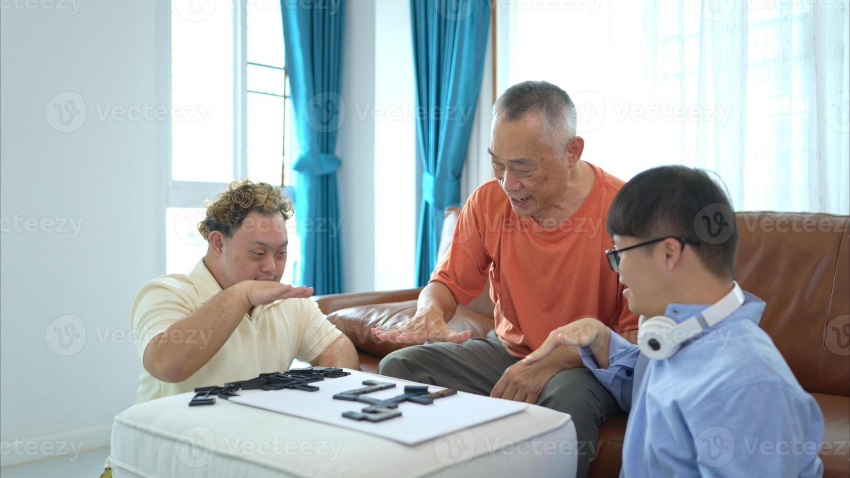 A father with grandchild plays games together in the living room to relax during the holidays photo