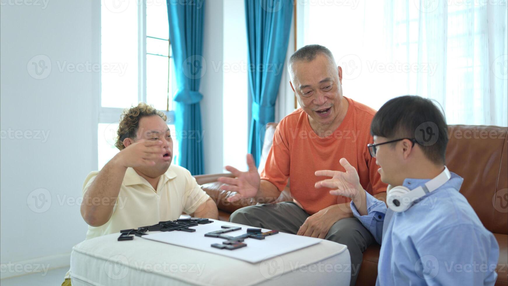 A father with grandchild plays games together in the living room to relax during the holidays photo