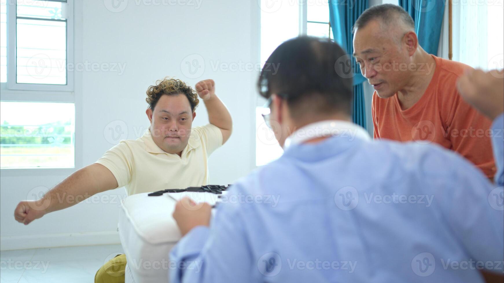 A father with grandchild plays games together in the living room to relax during the holidays photo