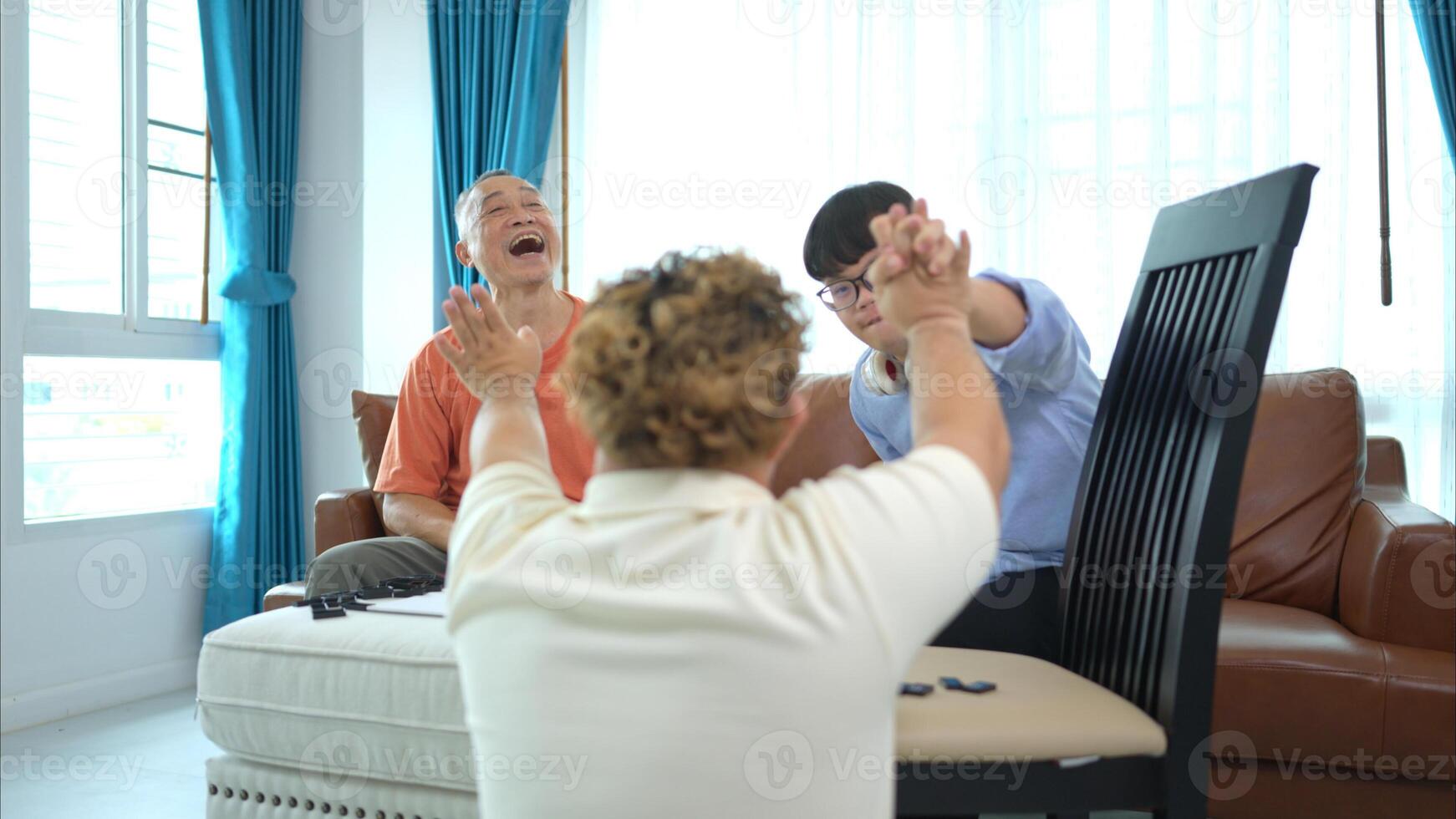 A father with grandchild plays games together in the living room to relax during the holidays photo
