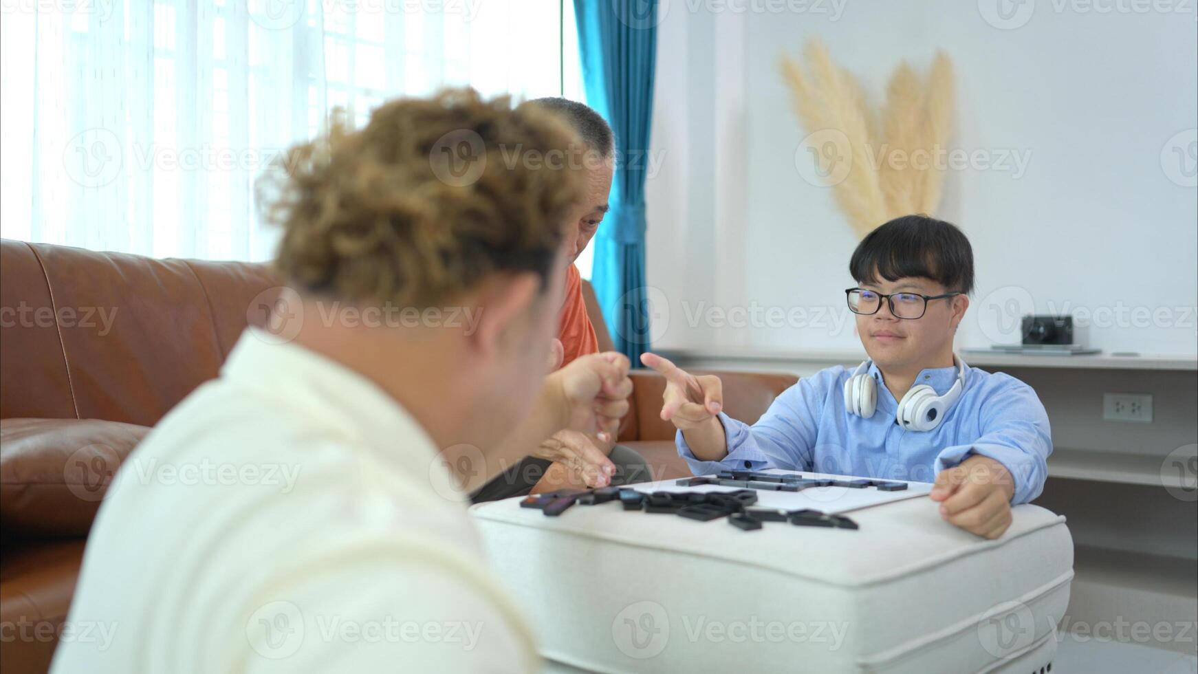 A father with grandchild plays games together in the living room to relax during the holidays photo