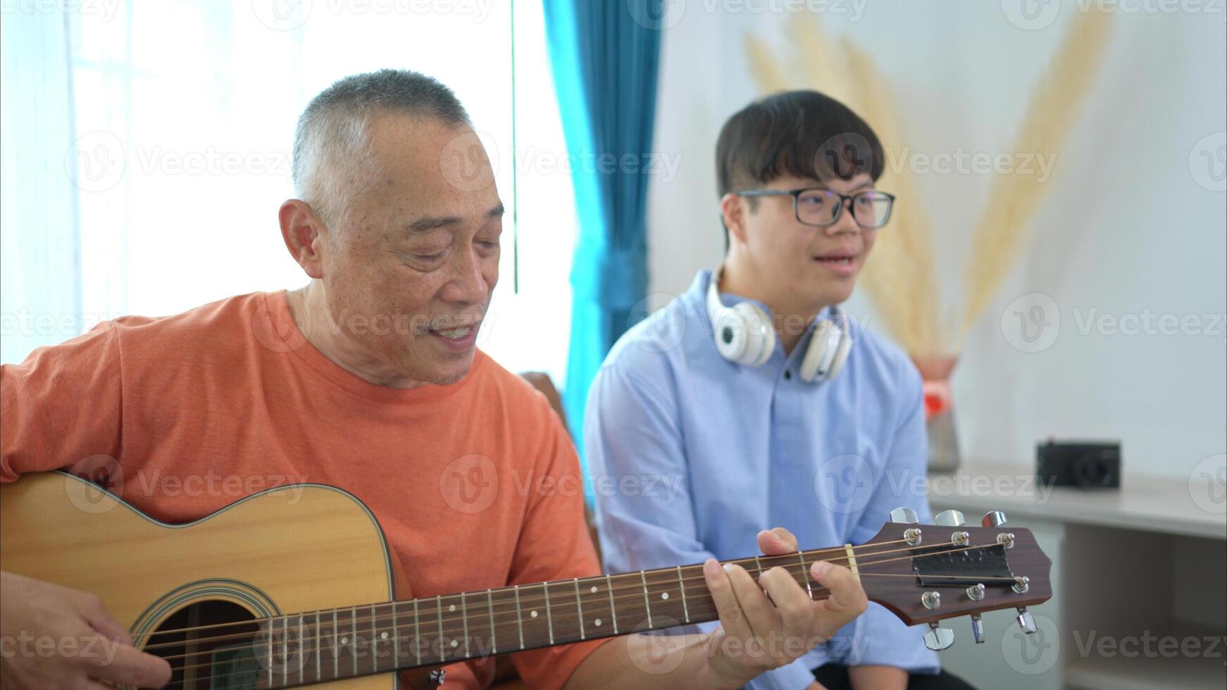 A family with an autistic child enjoys singing and dancing together at home during the holidays photo