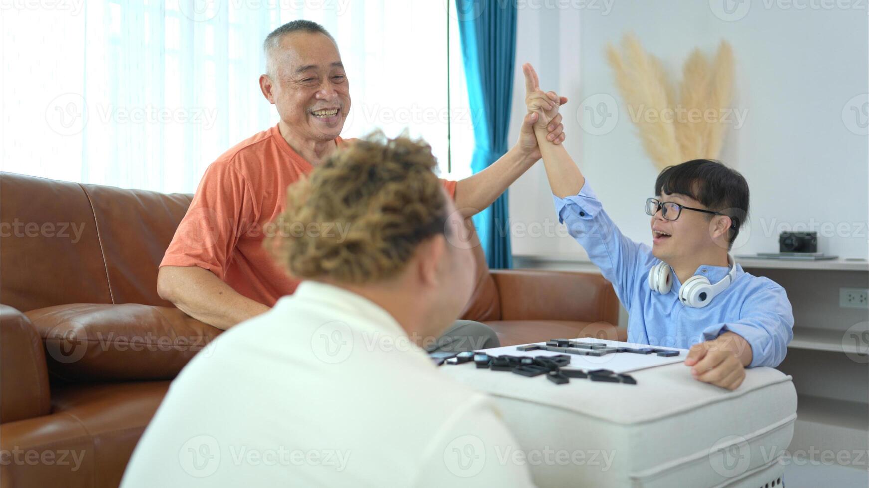 A father with grandchild plays games together in the living room to relax during the holidays photo