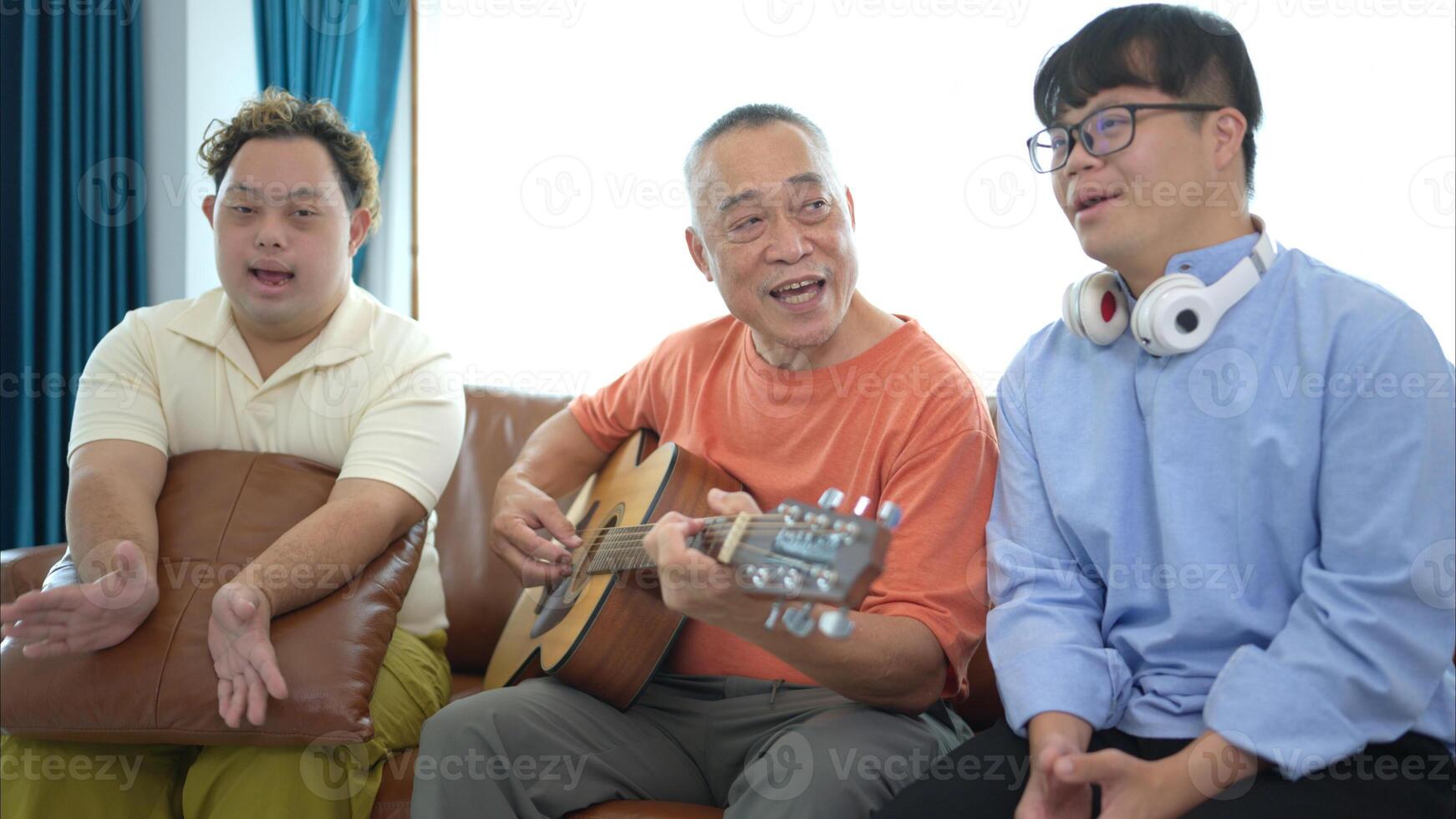 A family with an autistic child enjoys singing and dancing together at home during the holidays photo