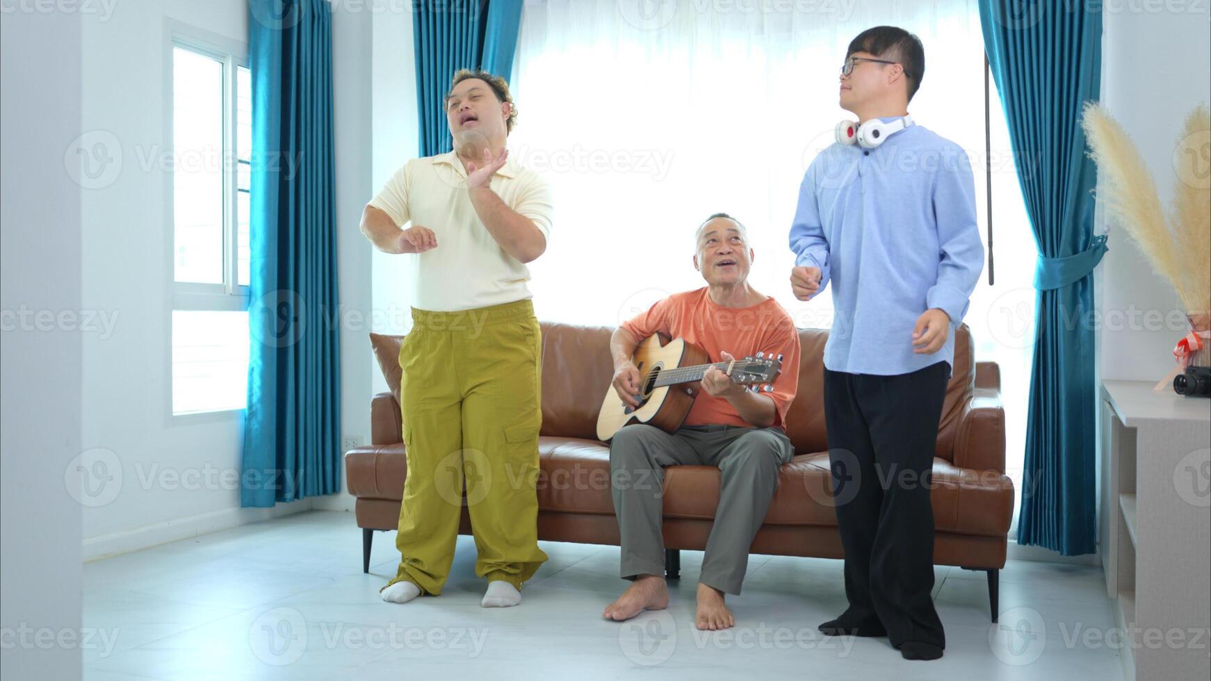 A family with an autistic child enjoys singing and dancing together at home during the holidays photo
