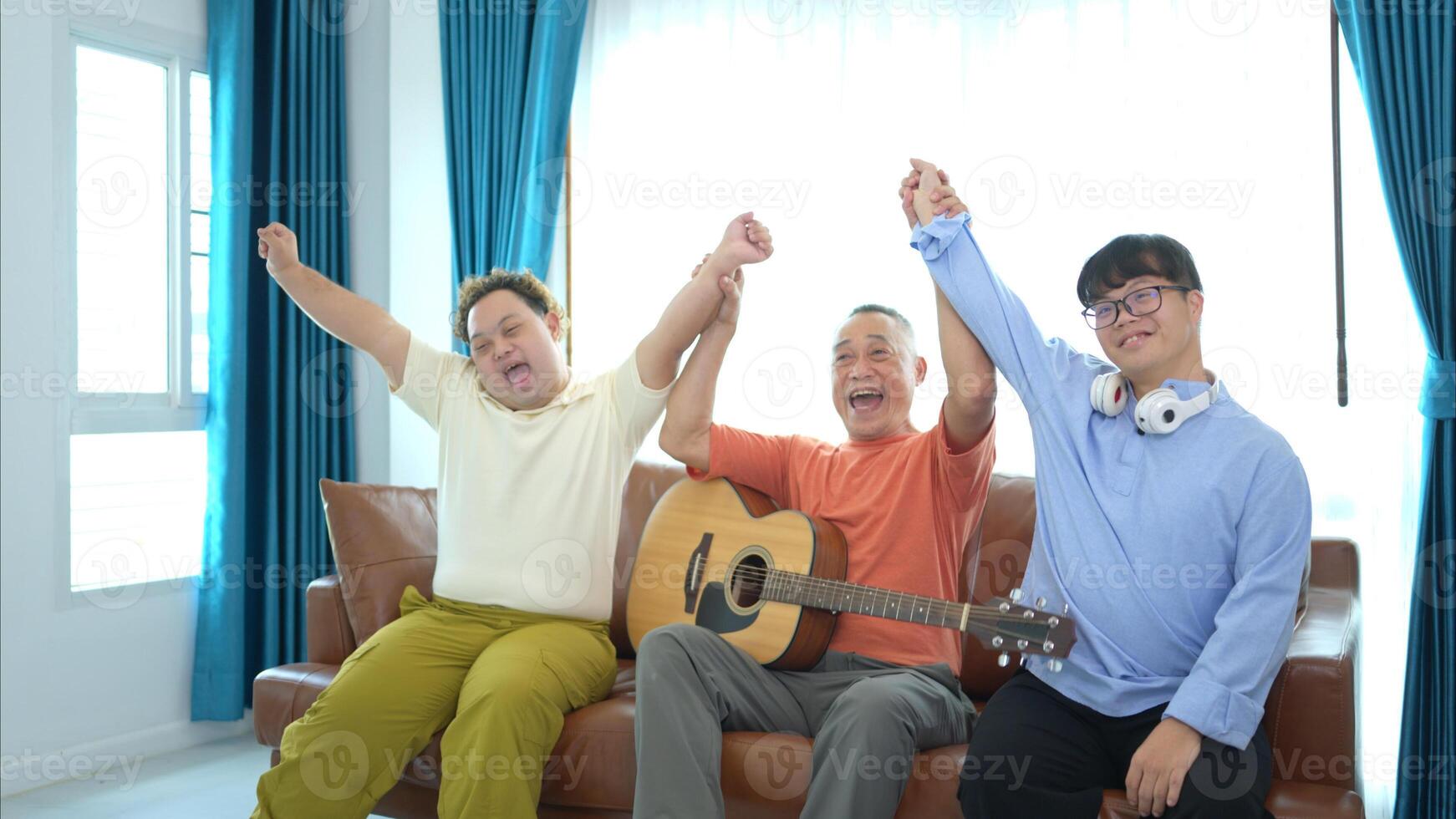 A family with an autistic child enjoys singing and dancing together at home during the holidays photo