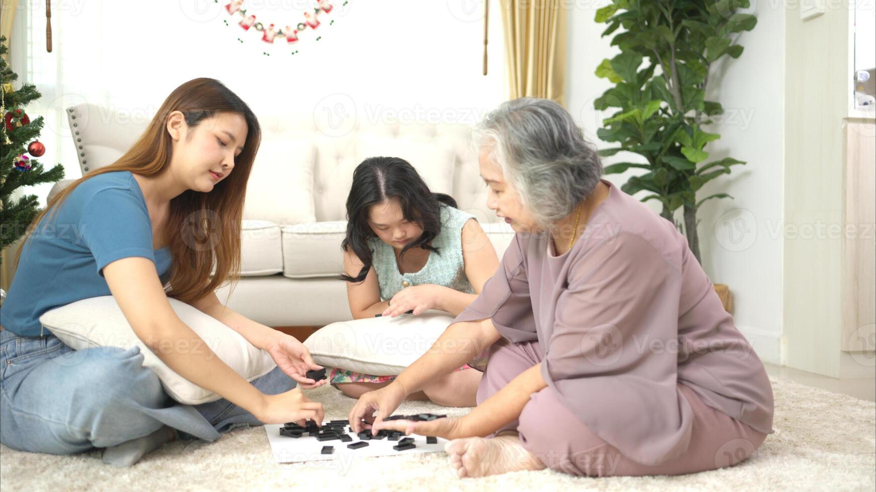 A family with an autistic child plays games together in the living room to relax during the holidays photo