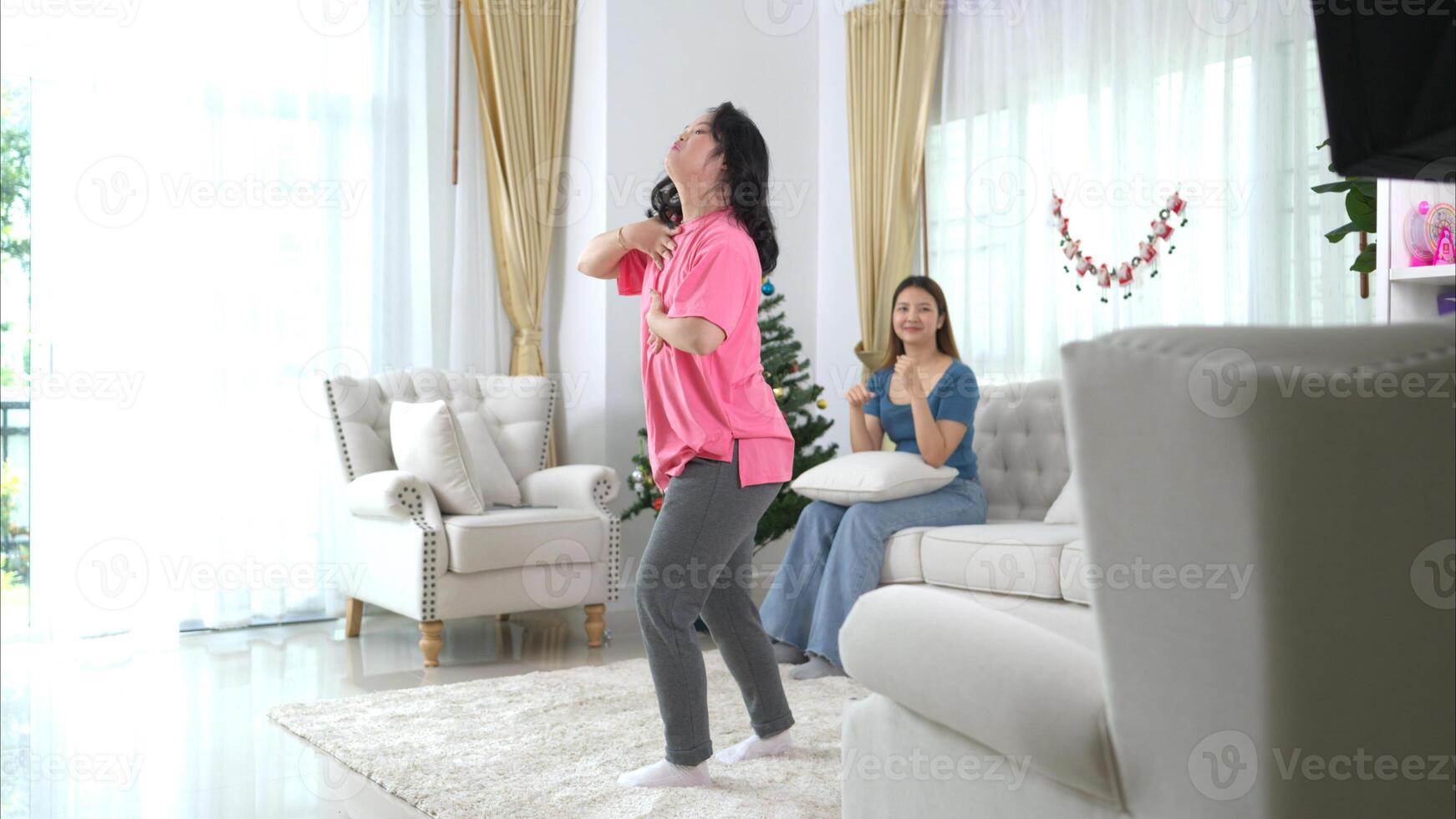 Two sister enjoys dancing together at home during the holidays photo