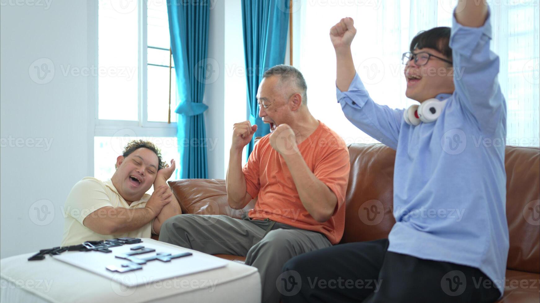 A father with grandchild plays games together in the living room to relax during the holidays photo