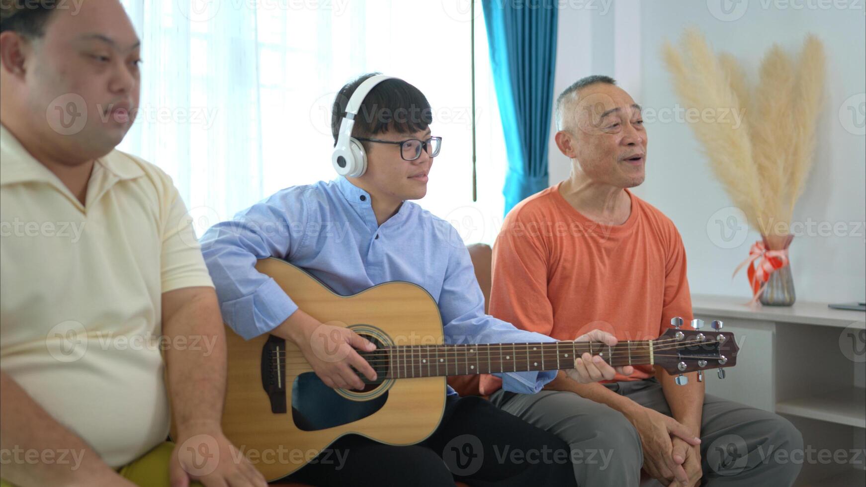 A family with an autistic child enjoys singing and dancing together at home during the holidays photo