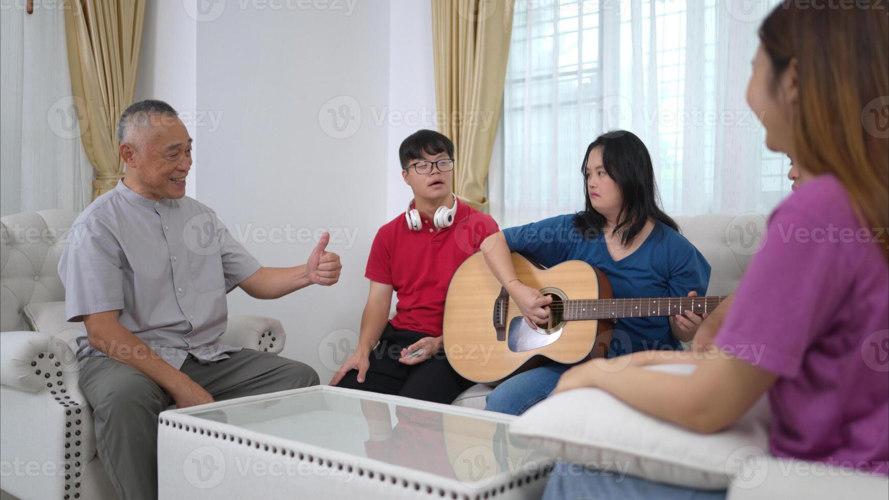 A grandfather with grandchild enjoys singing and dancing together at home during the holidays photo