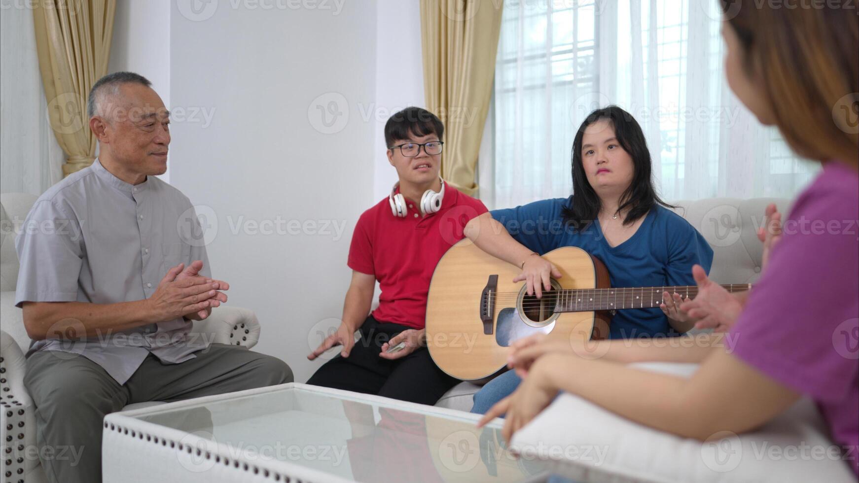 A grandfather with grandchild enjoys singing and dancing together at home during the holidays photo