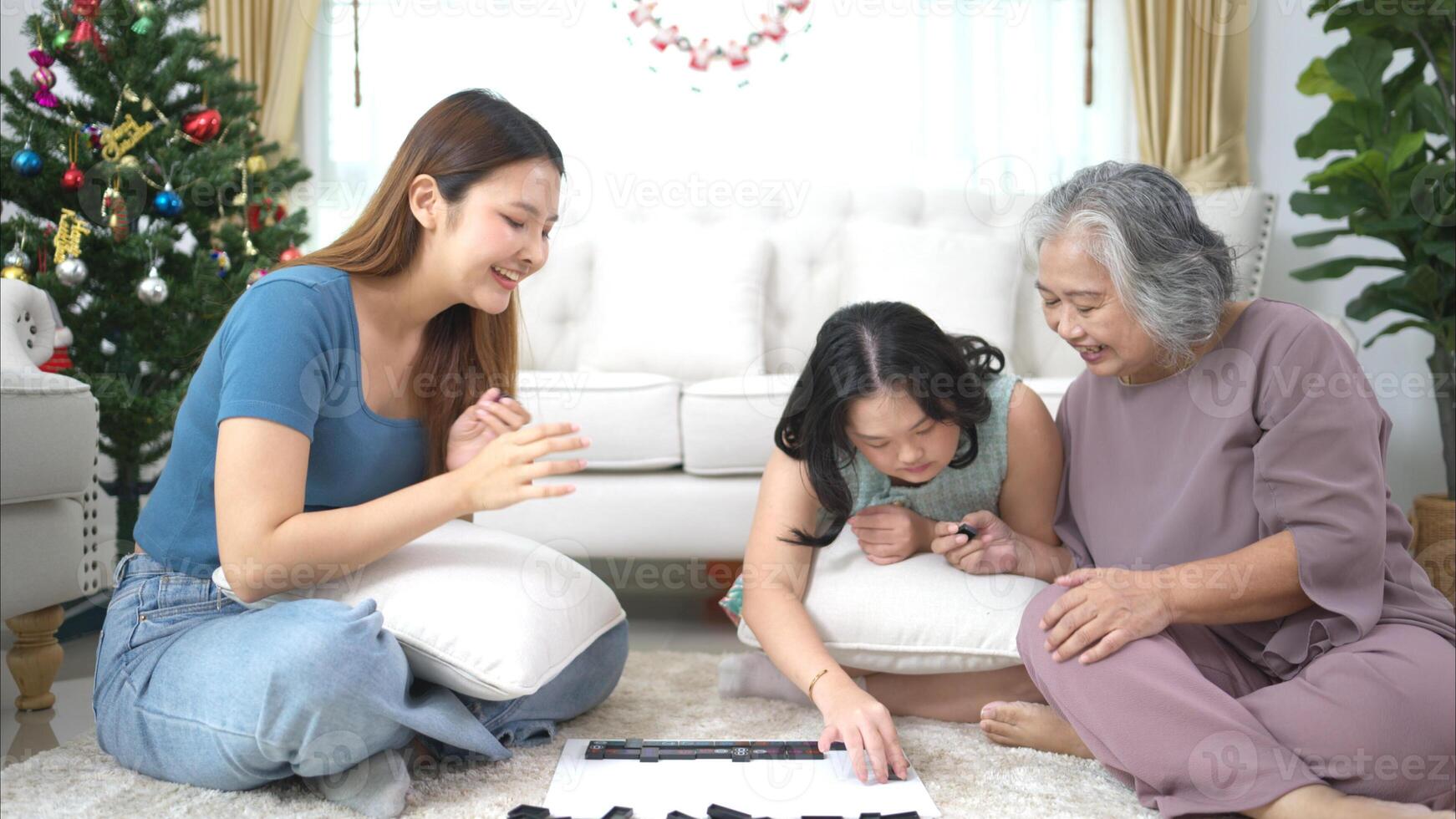 A family with an autistic child plays games together in the living room to relax during the holidays photo