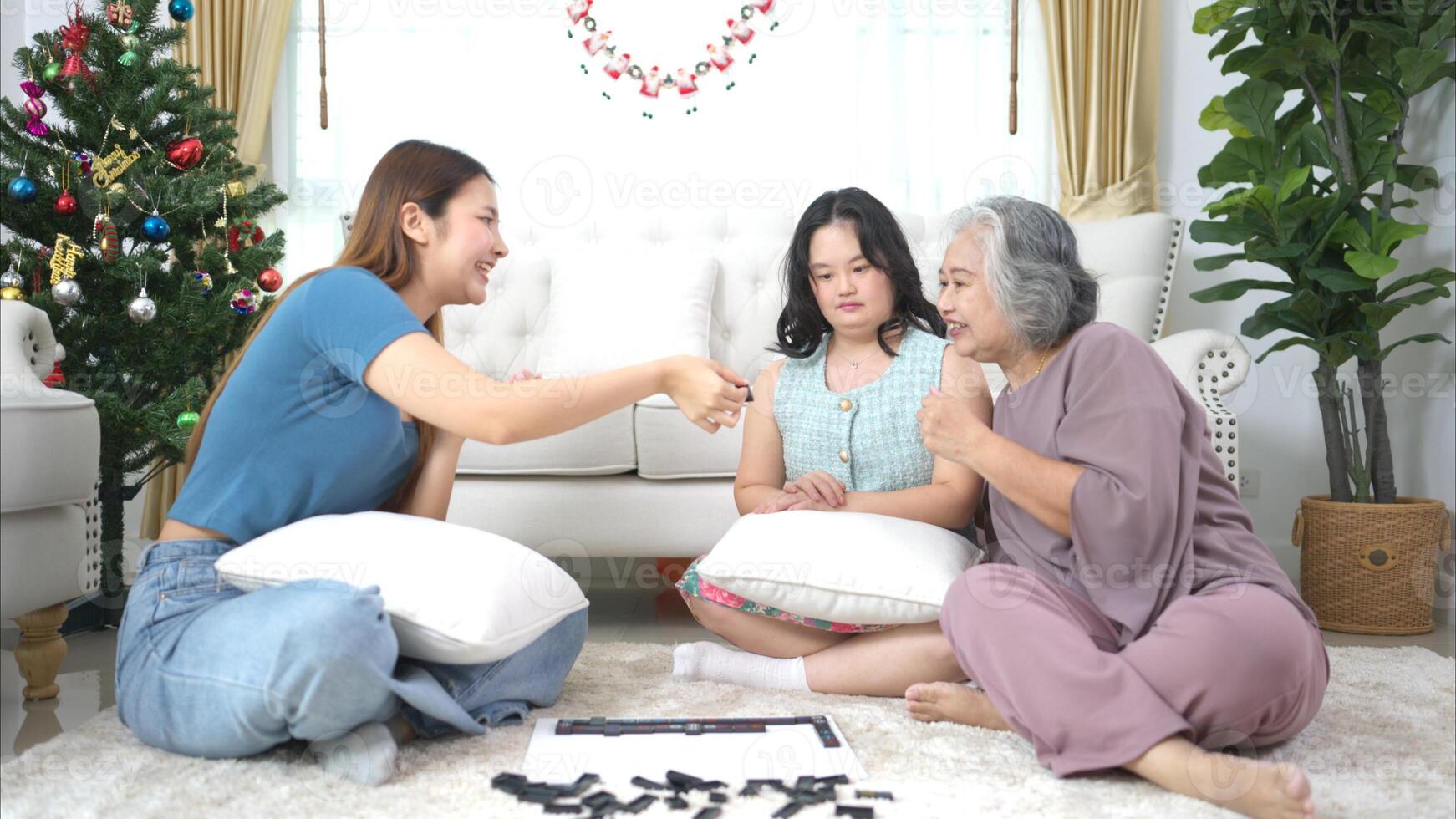 A family with an autistic child plays games together in the living room to relax during the holidays photo