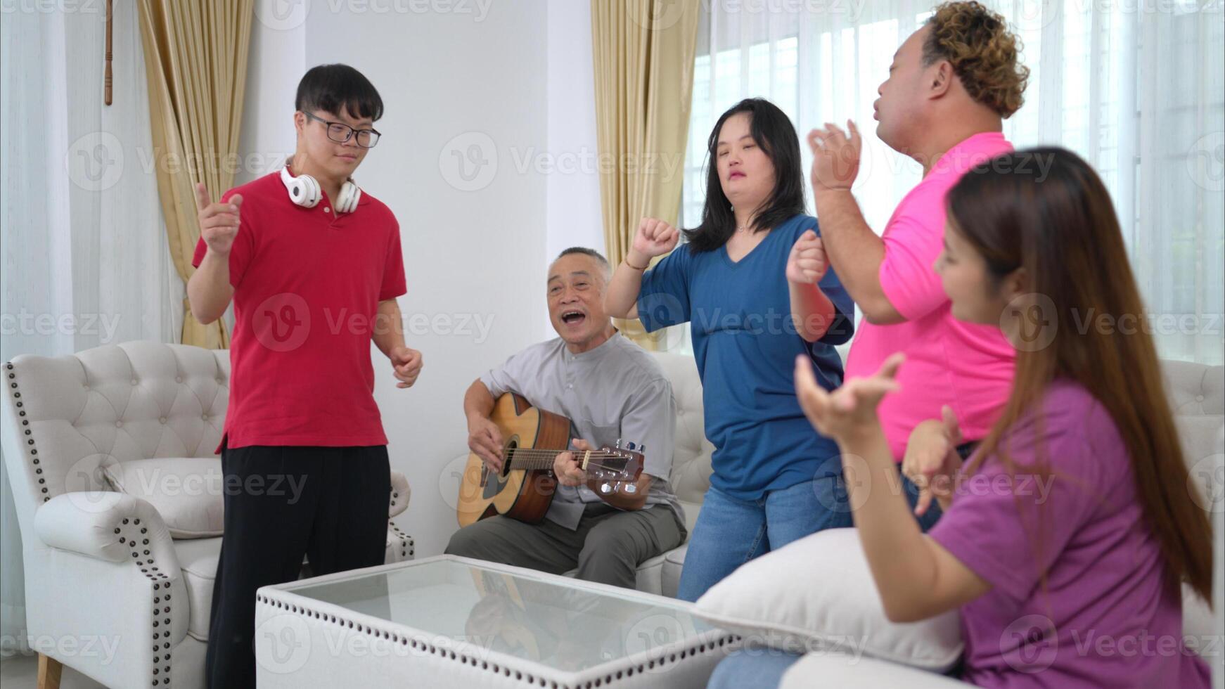 A grandfather with grandchild enjoys singing and dancing together at home during the holidays photo